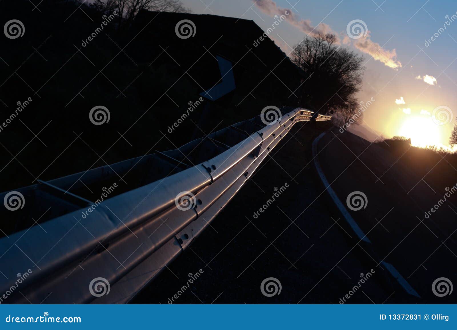 guardrail vanish on road at sunset