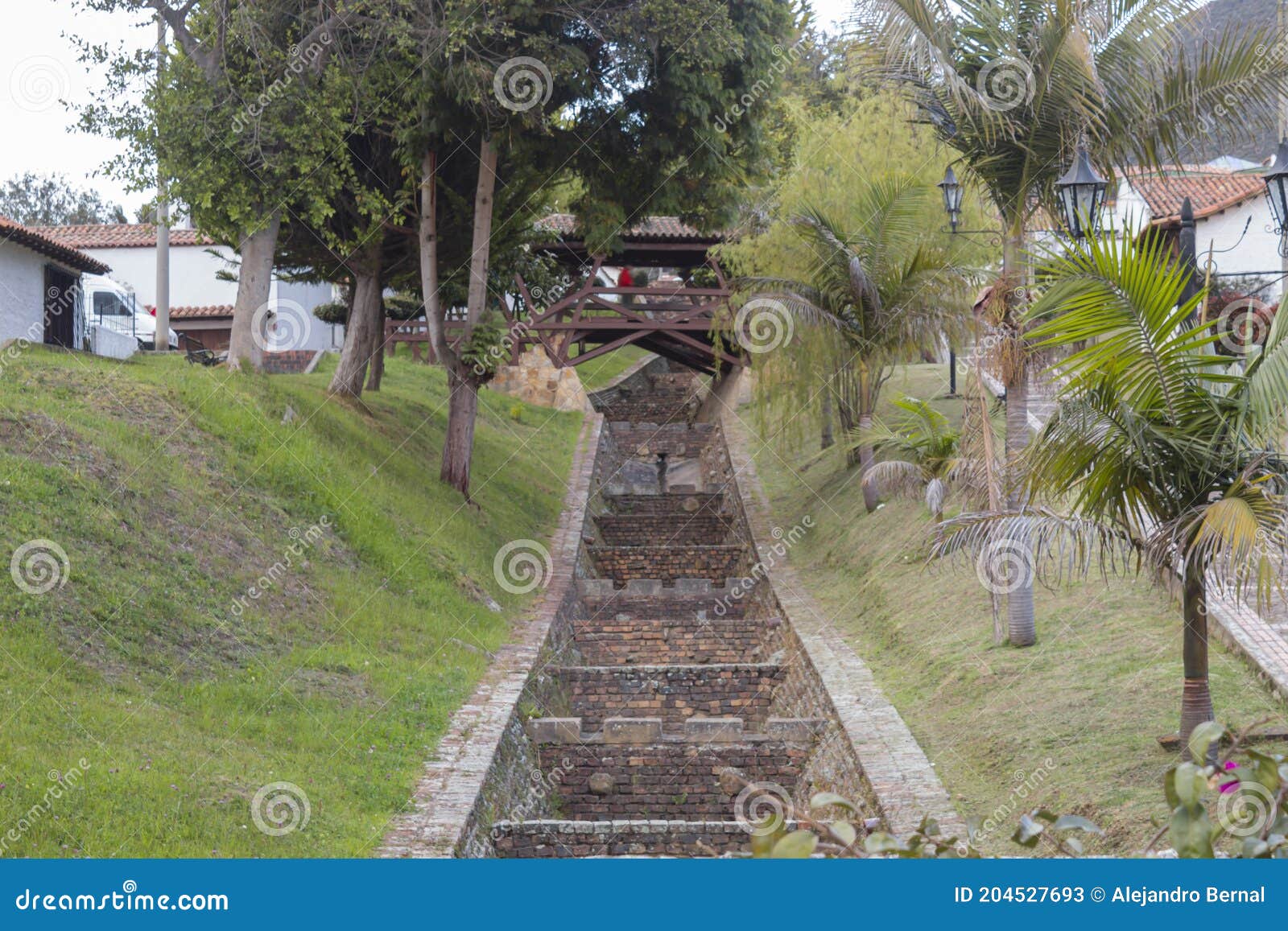 guatavita main river with lovers bridge or in spanish `puente de los enamorados` with grass garden