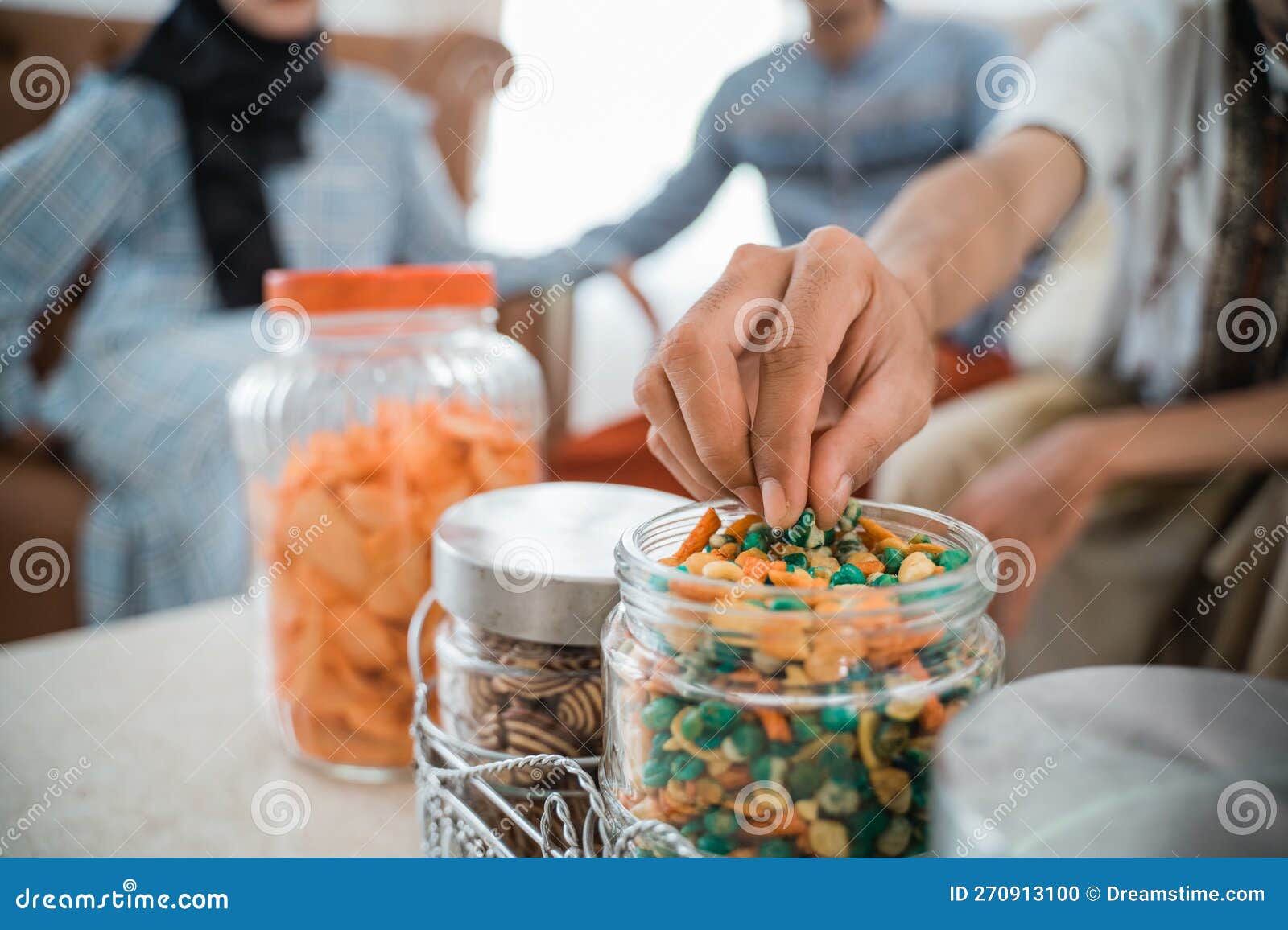 Guest& X27;s Hand Takes a Snack from a Jar on Table Stock Photo - Image