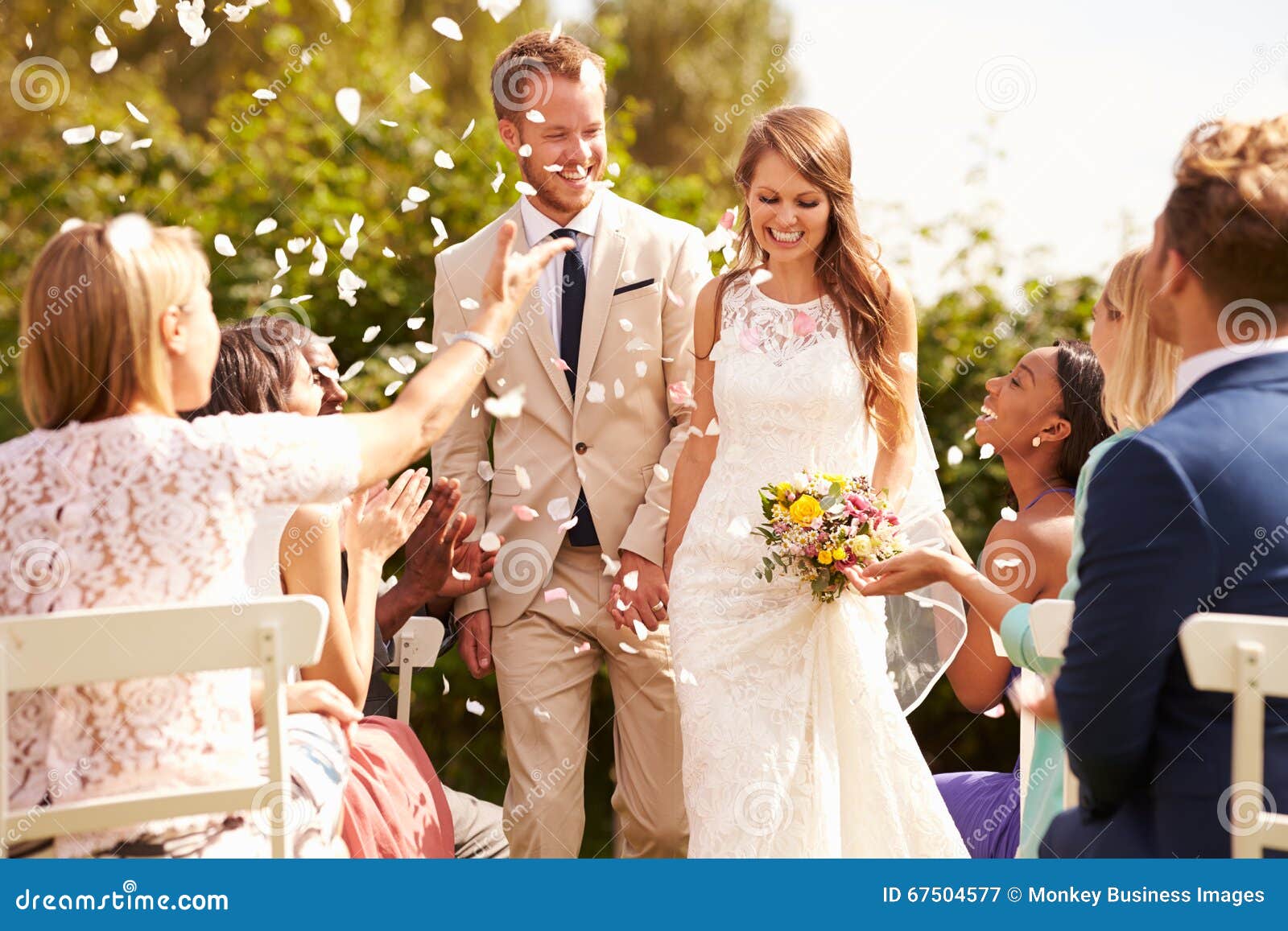 guests throwing confetti over bride and groom at wedding