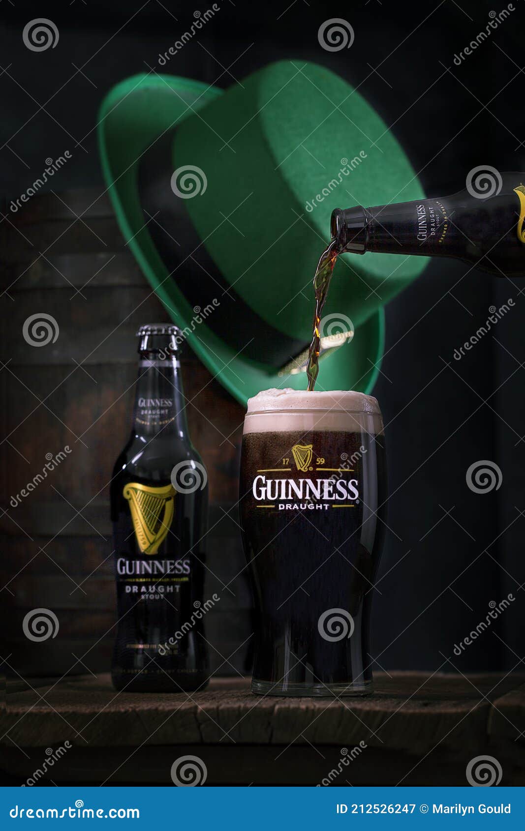 https://thumbs.dreamstime.com/z/guinness-pouring-pint-glass-st-patricks-day-bottle-draght-logo-image-green-patrick-s-hat-wood-barrel-blurred-212526247.jpg