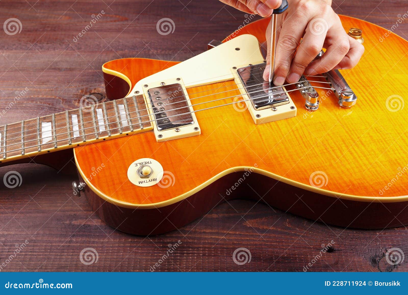 Guitar Master Adjusts Pickups on Electric Guitar at Workplace Stock