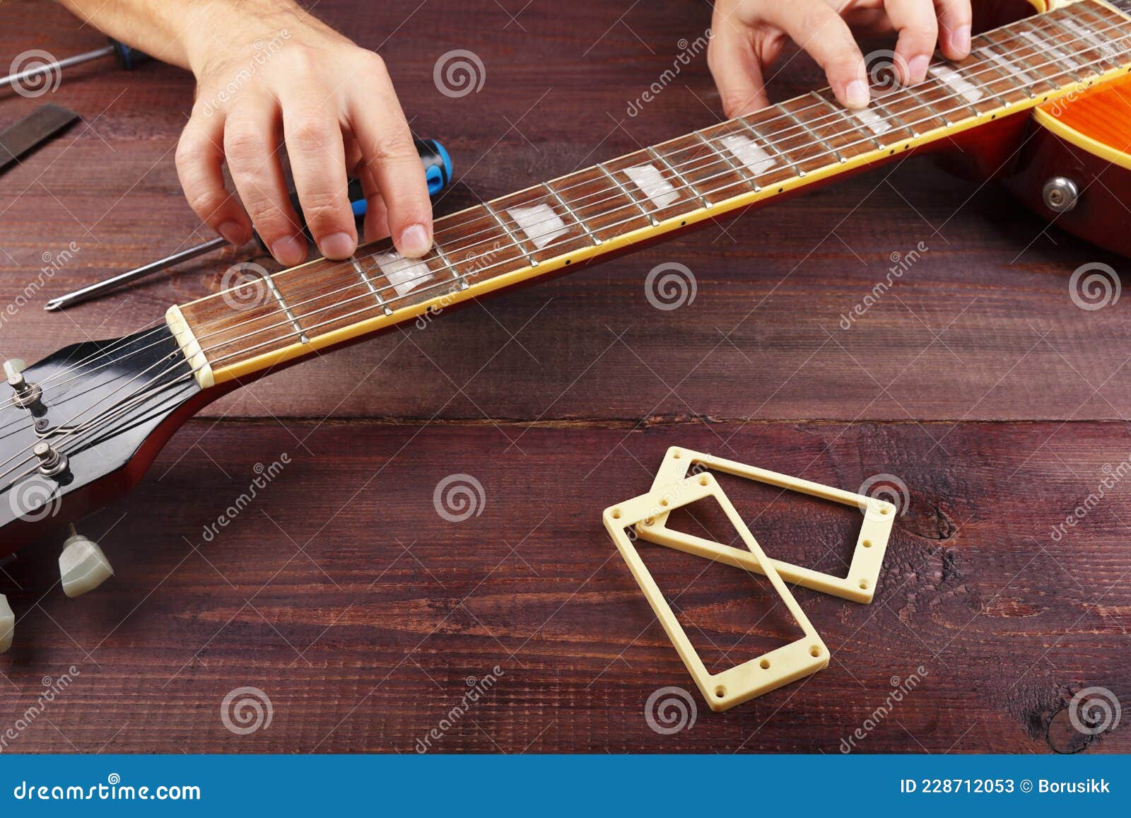 Guitar Master Checking the Relief of Neck on Electric Guitar at