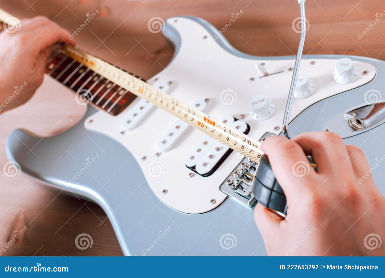 Guitar Master Doing Guitar Scale Measurement for Saddle Adjustment