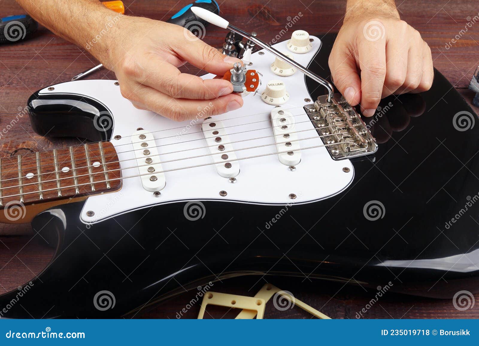 Guitar Master Selects Potentiometer for Replacement on Electric Guitar