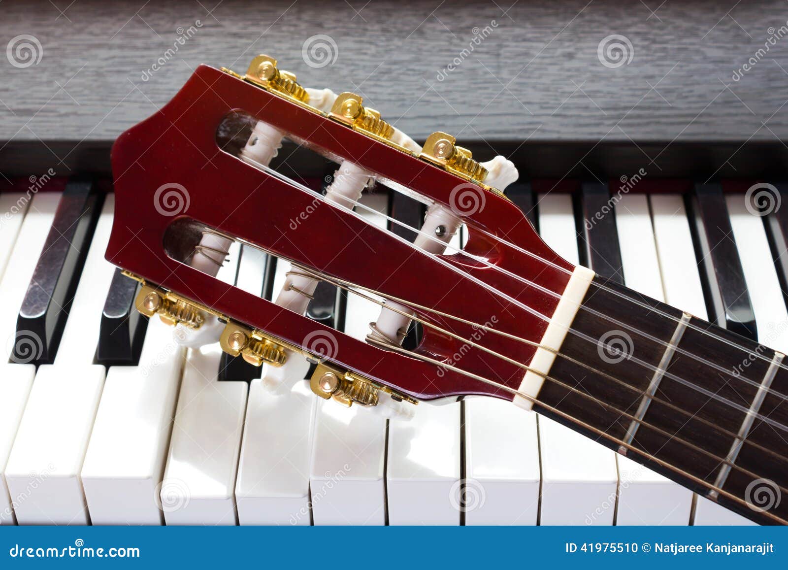 Guitar neck on piano keys stock photo. Image of melody 41975510