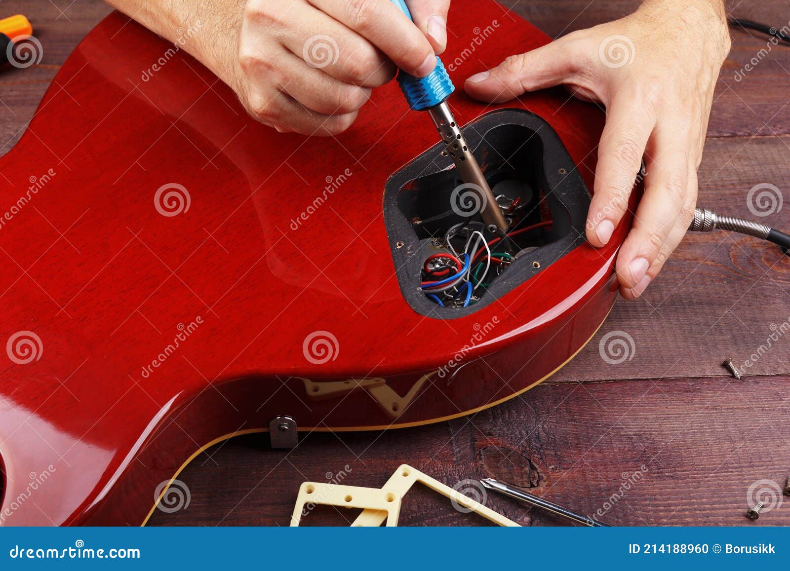 Guitar Repairer Soldering Electric Guitar Electronics in Workplace