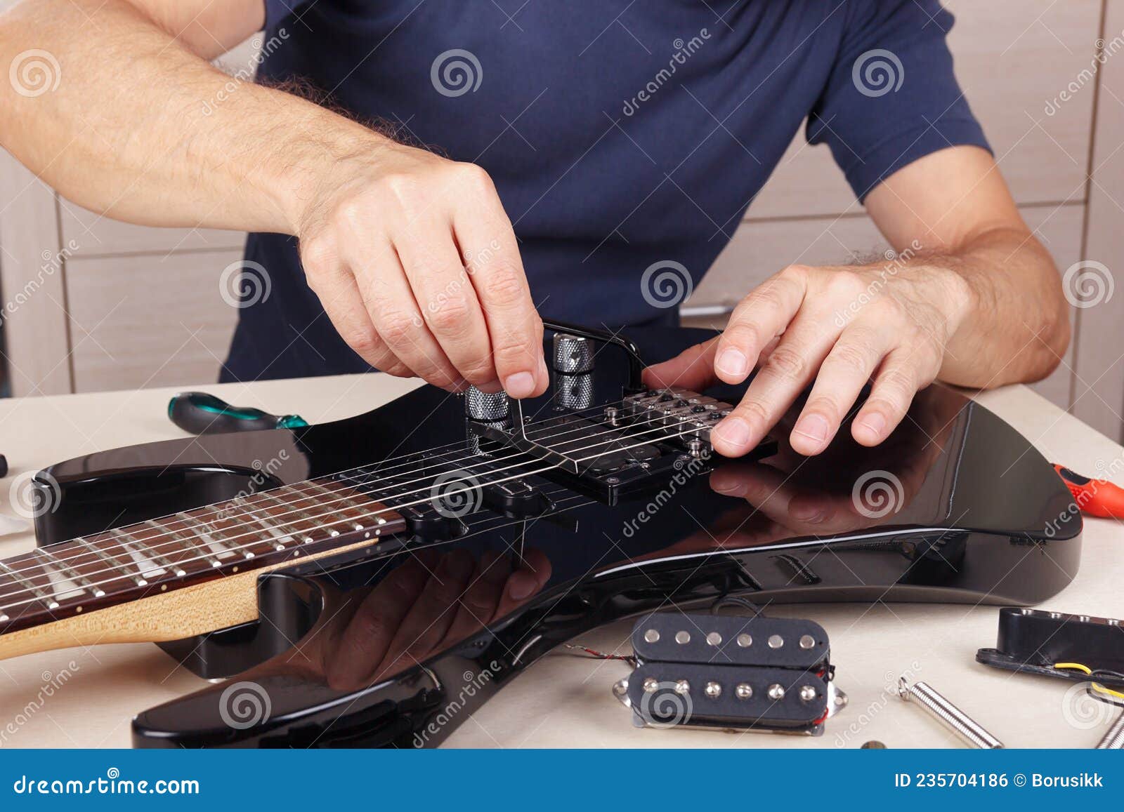 Guitar Technician Checking Radius of Strings on Modern Electric Guitar