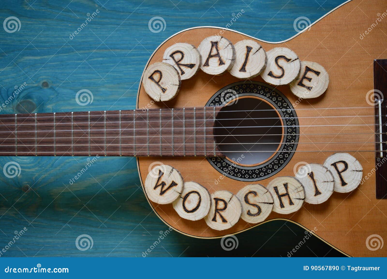 guitar on wood with words: praise and worship