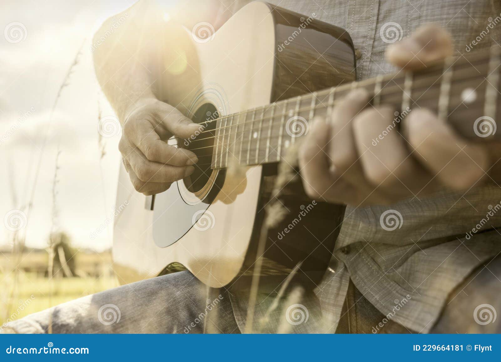 Guitarist Playing Acoustic Guitar Outside in Field Stock Image - Image