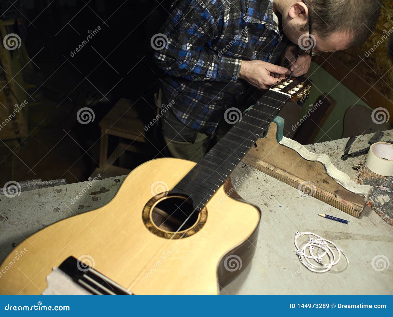 Guitars Luthiers Sets the Strings on a Guitar. Stock Image Image of