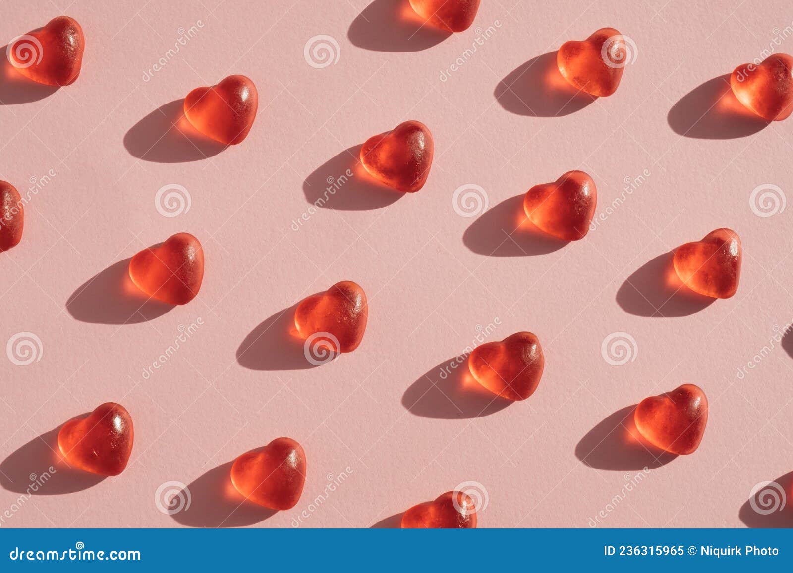 gummy heart d candy layout against pink coral background.