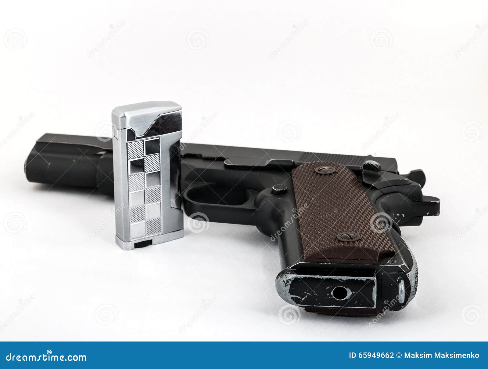 Gun (Colt 1911) and a Lighter on a Light Background Stock Photo Image
