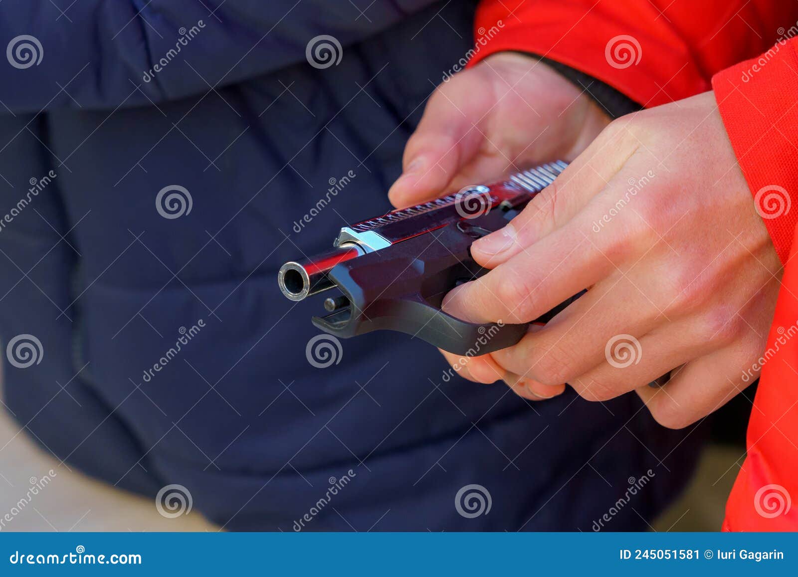 A Gun in the Hands of a Young Man, Selective Focus. Reloading Weapons