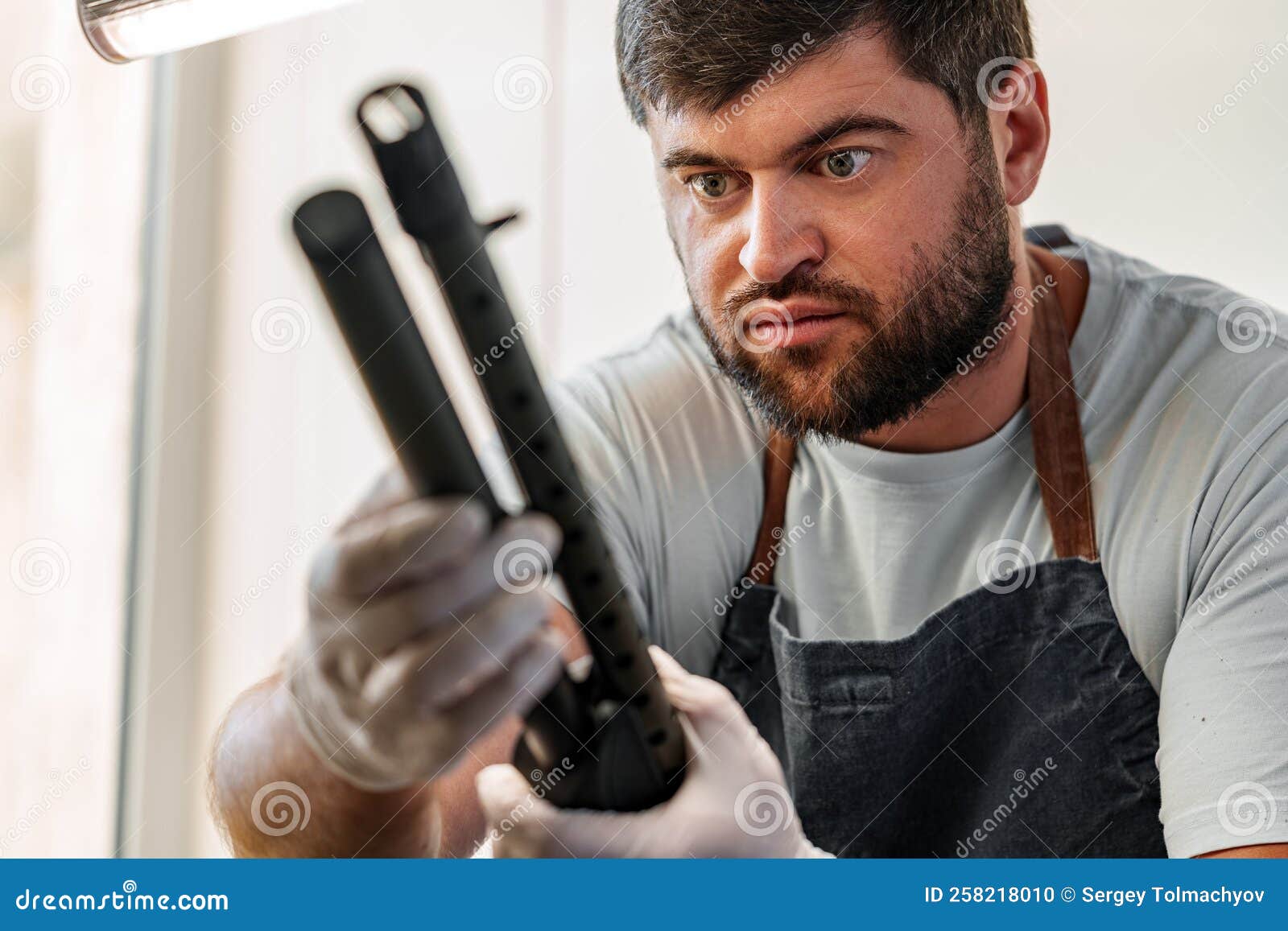 The Gunsmith Maintaining His Rifle in a Stock Photo Image of