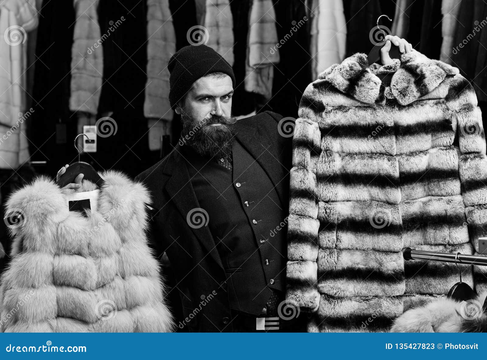 Guy with Cunning Face Shows Fur Coats in Fashion Store. Stock Image ...