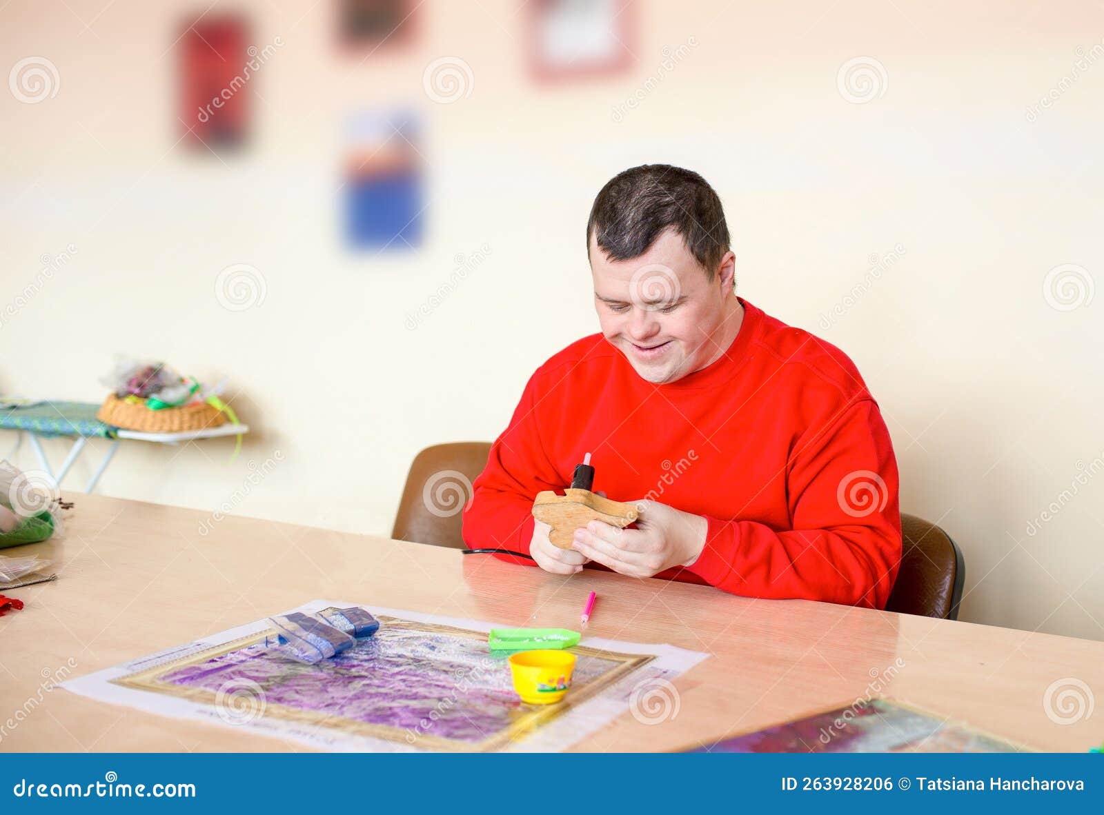 A Guy with Down Syndrome Does Needlework. Stock Photo Image of