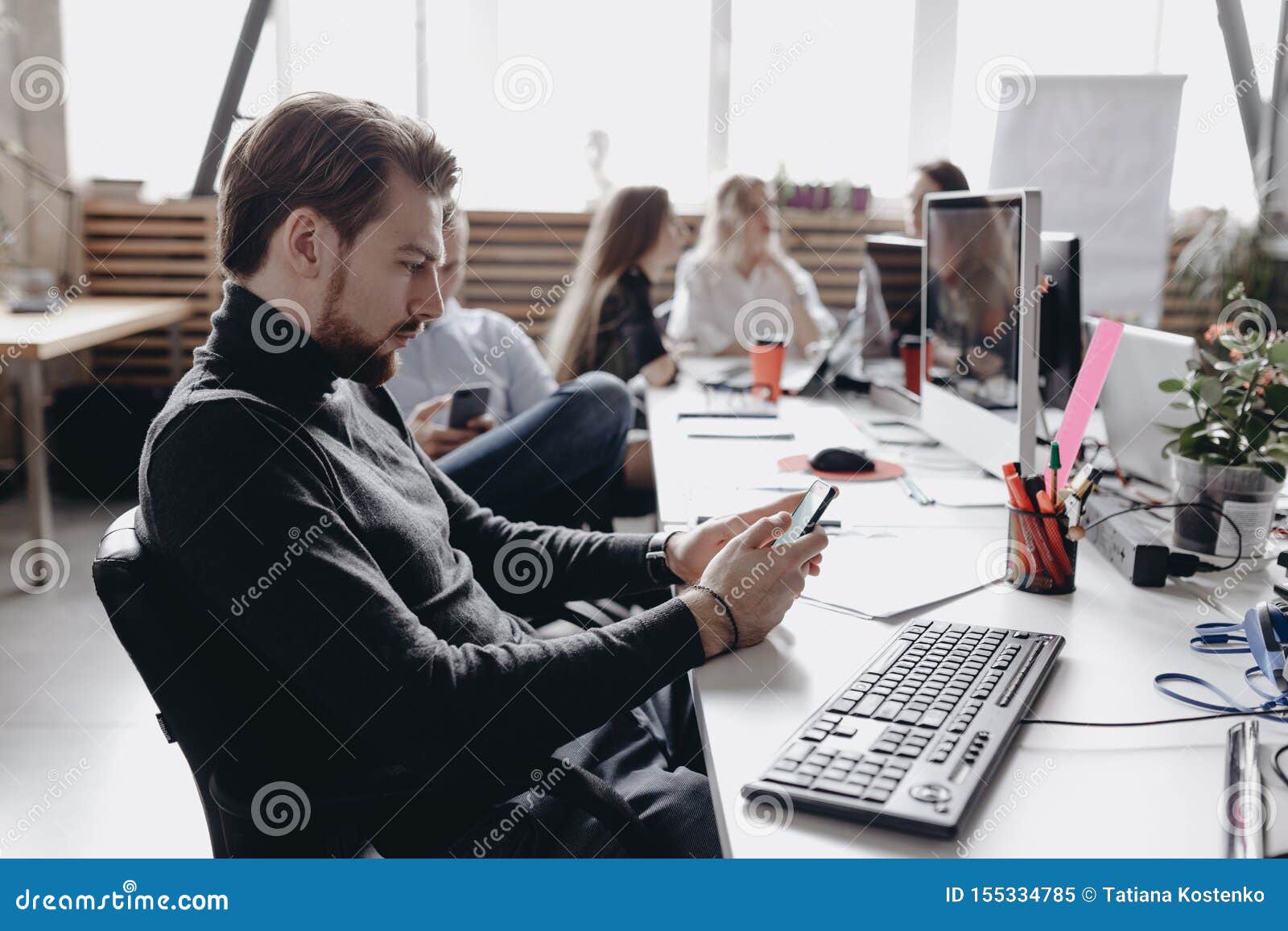 The Guy Dressed In Casual Office Style Clothes Is Working Sitting