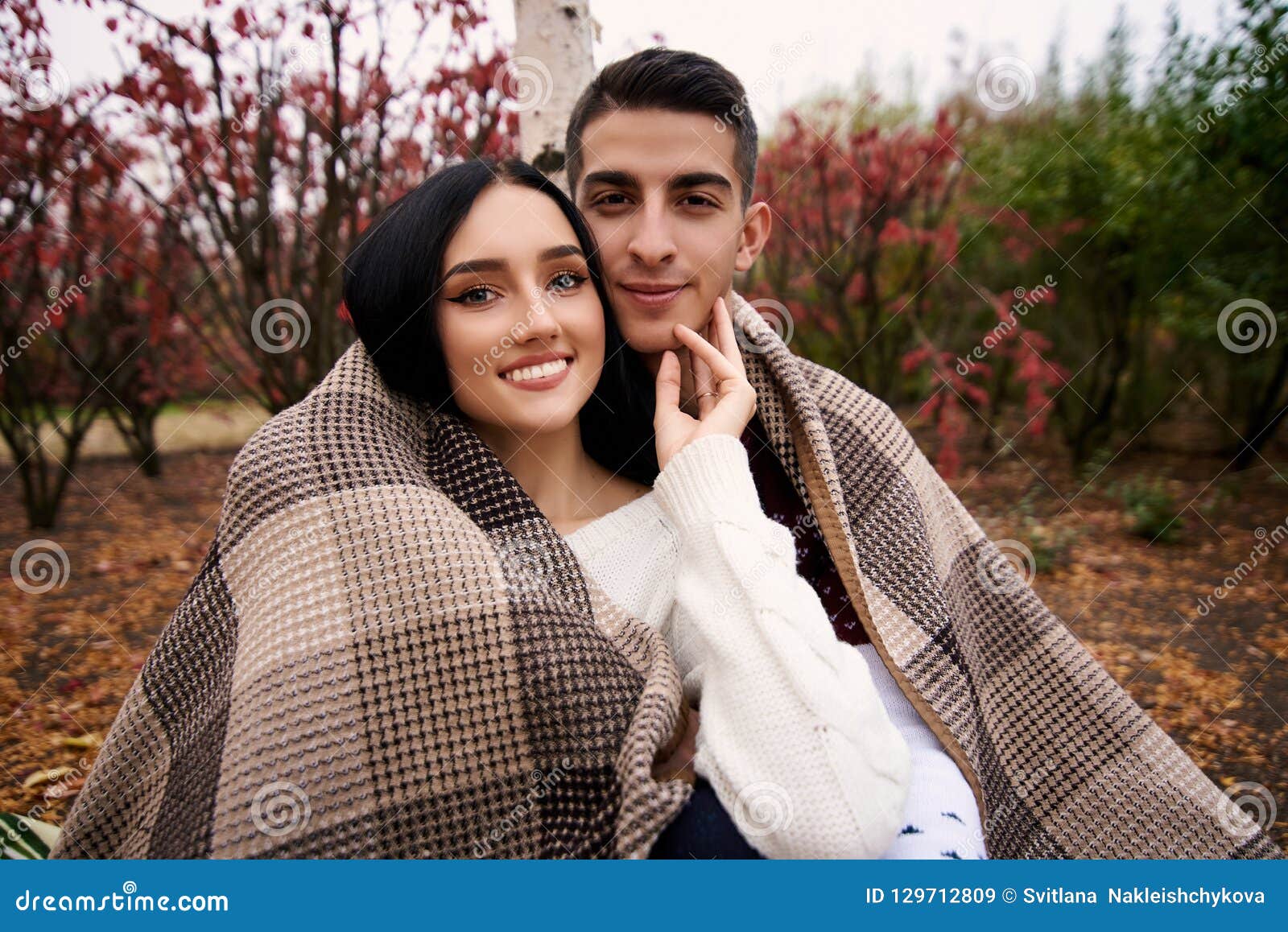 guy with a girl covered blanket