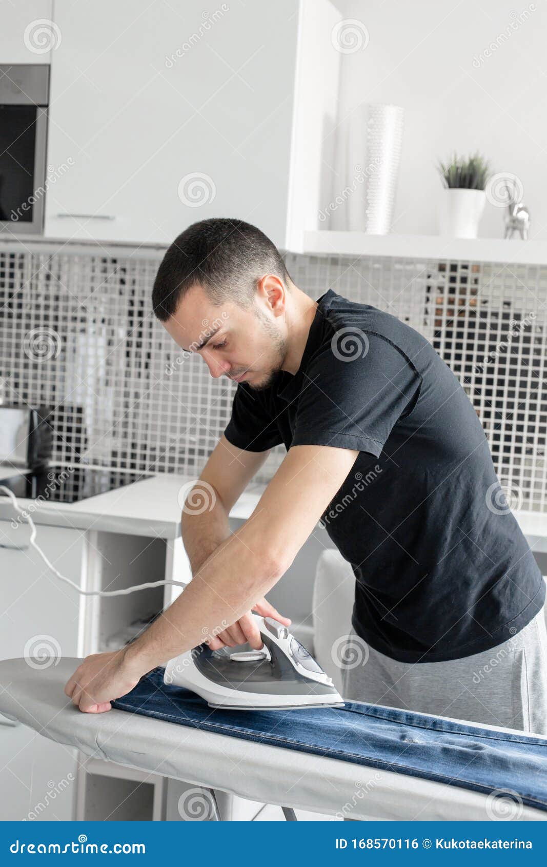 A Guy Ironing Clothes before Going Outside Stock Photo Image of