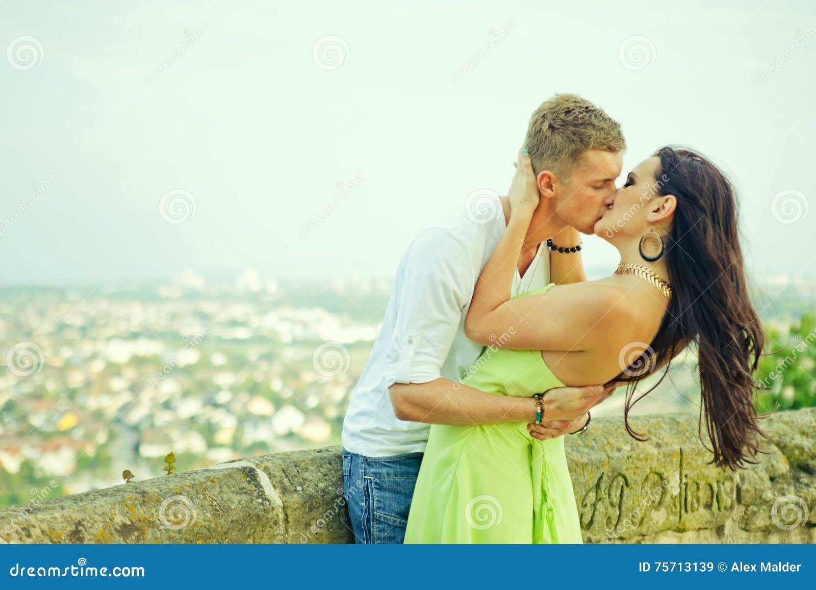 The guy kiss the girl stock image. Image of stone, embraces 75713139