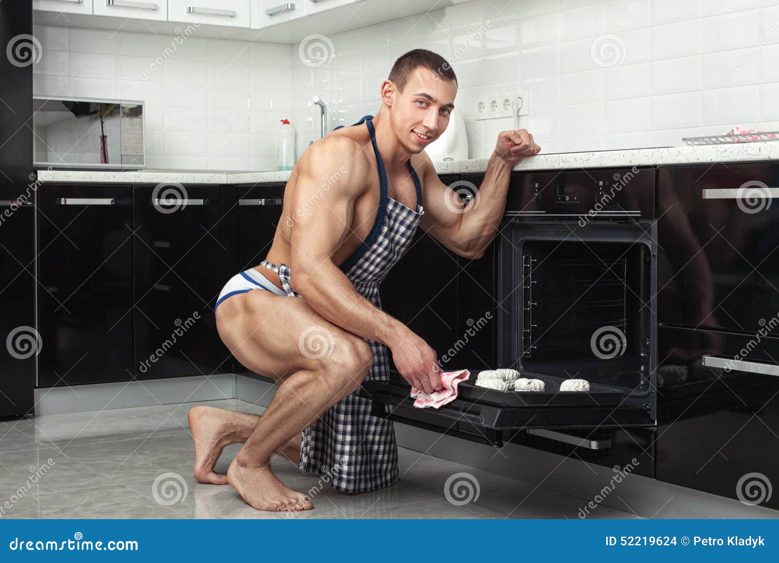 guy-kitchen-athletic-figure-preparing-52219624.jpg