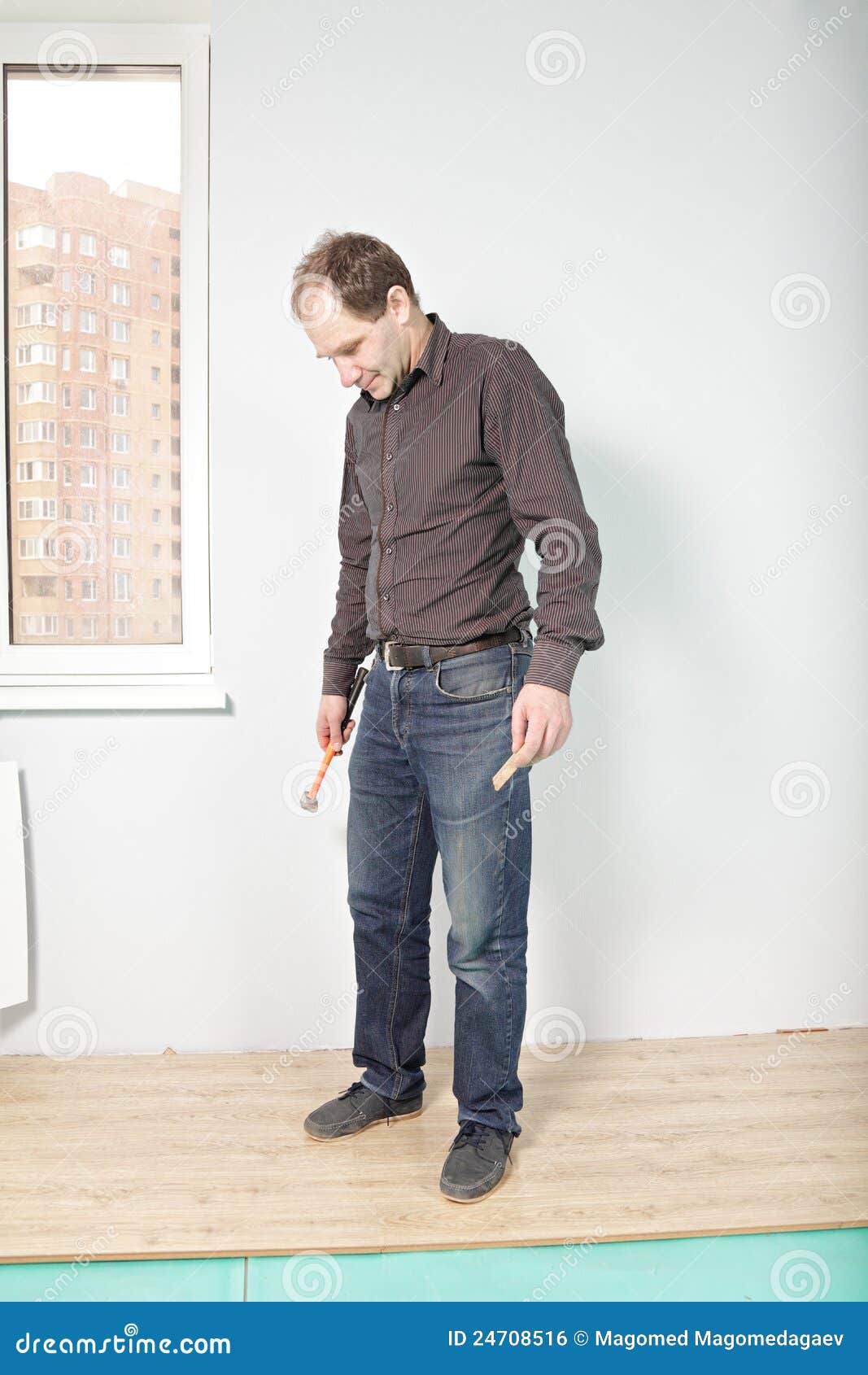 Guy looking at flooring stock photo. Image of room, hammer 24708516
