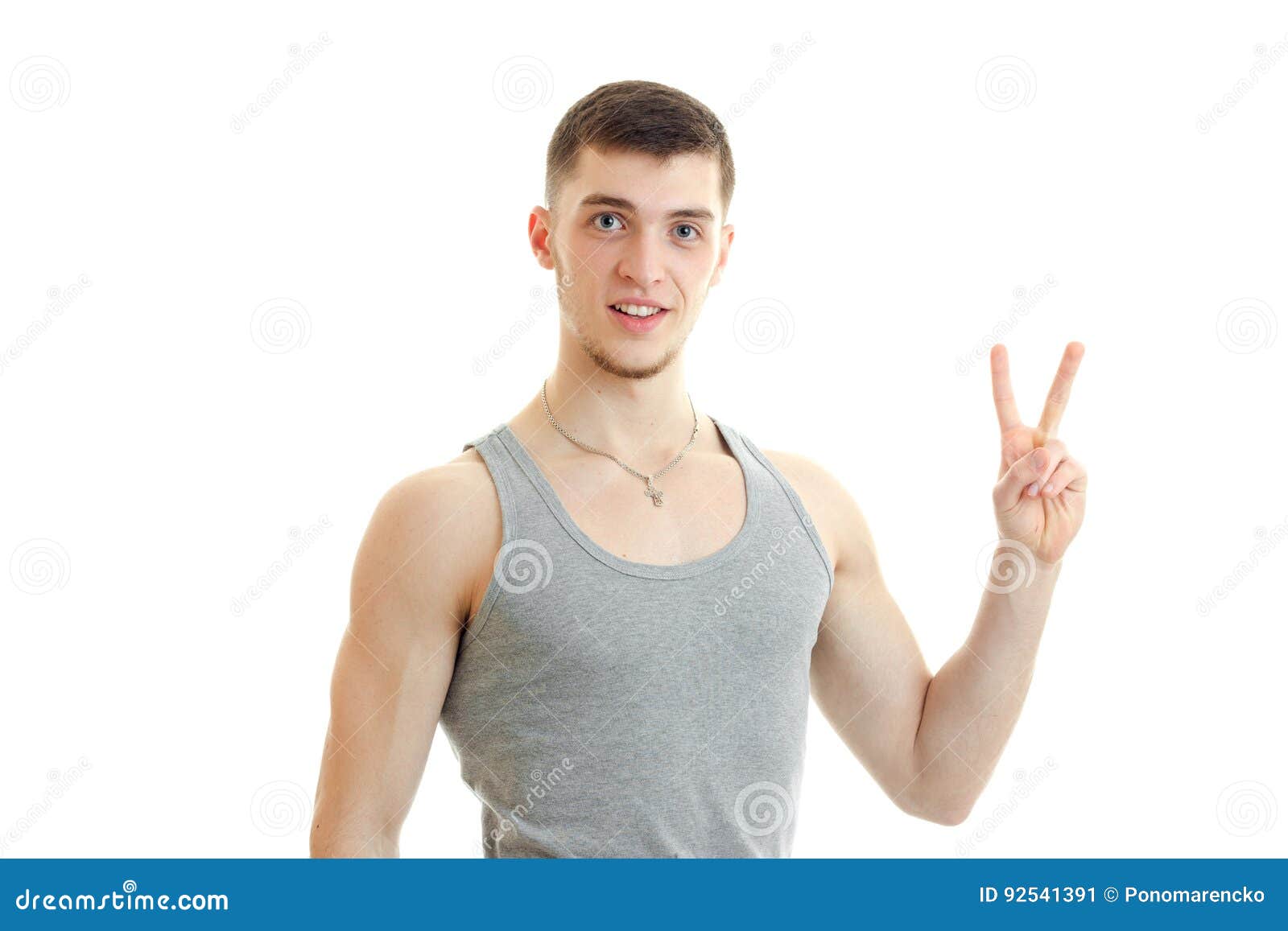 Guy Looks Into The Camera And Hand Gesture With Raised Up Two Fingers