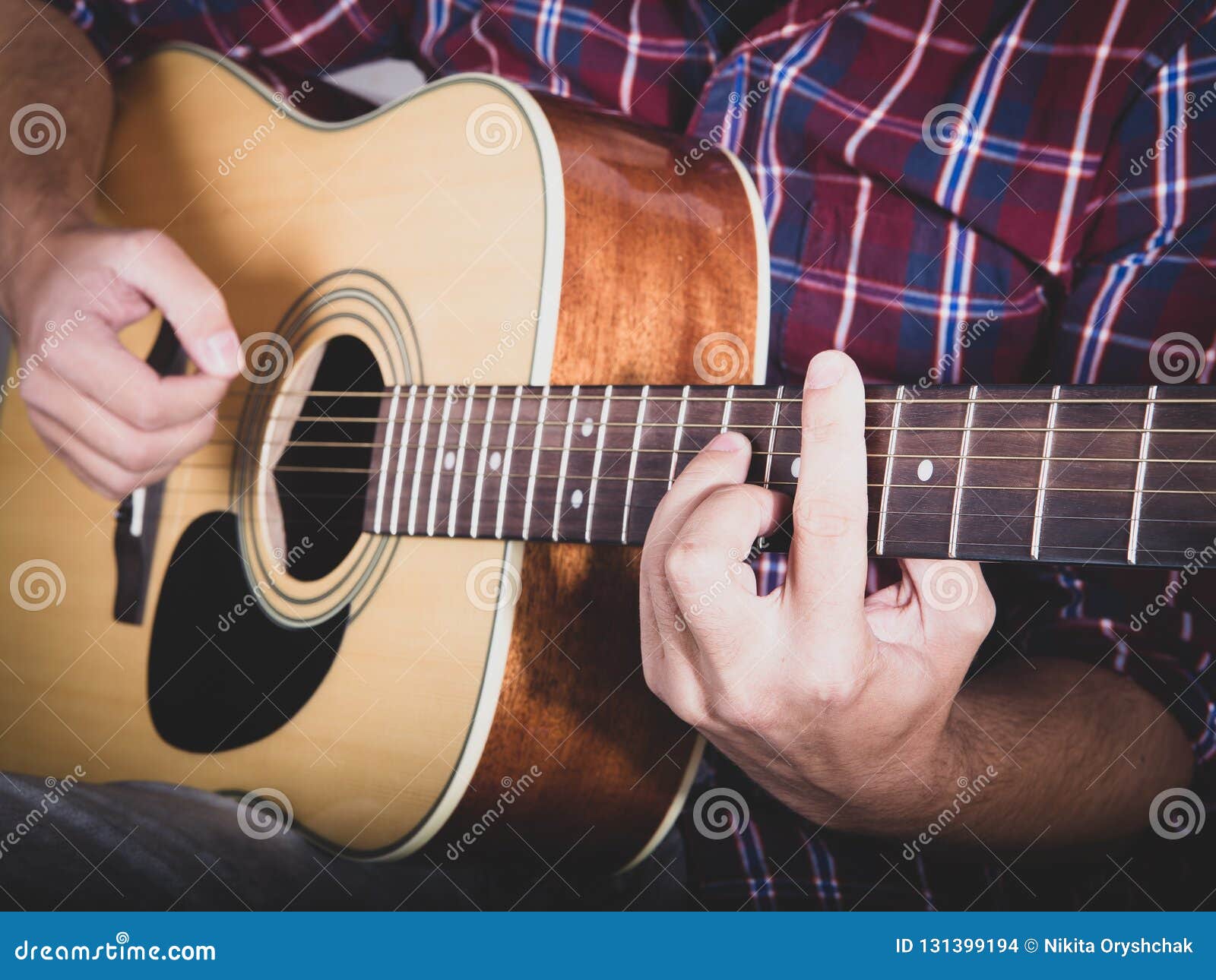 Guy Playing an Acoustic Guitar at a Recording Studio Stock Photo