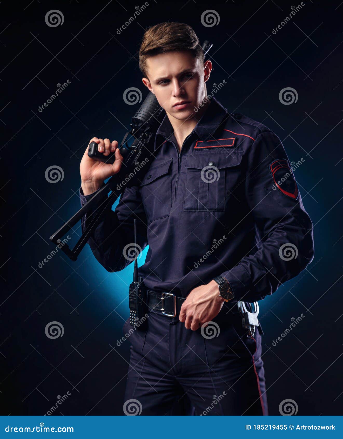 A Guy In A Police Uniform With A Short Barreled Automatic