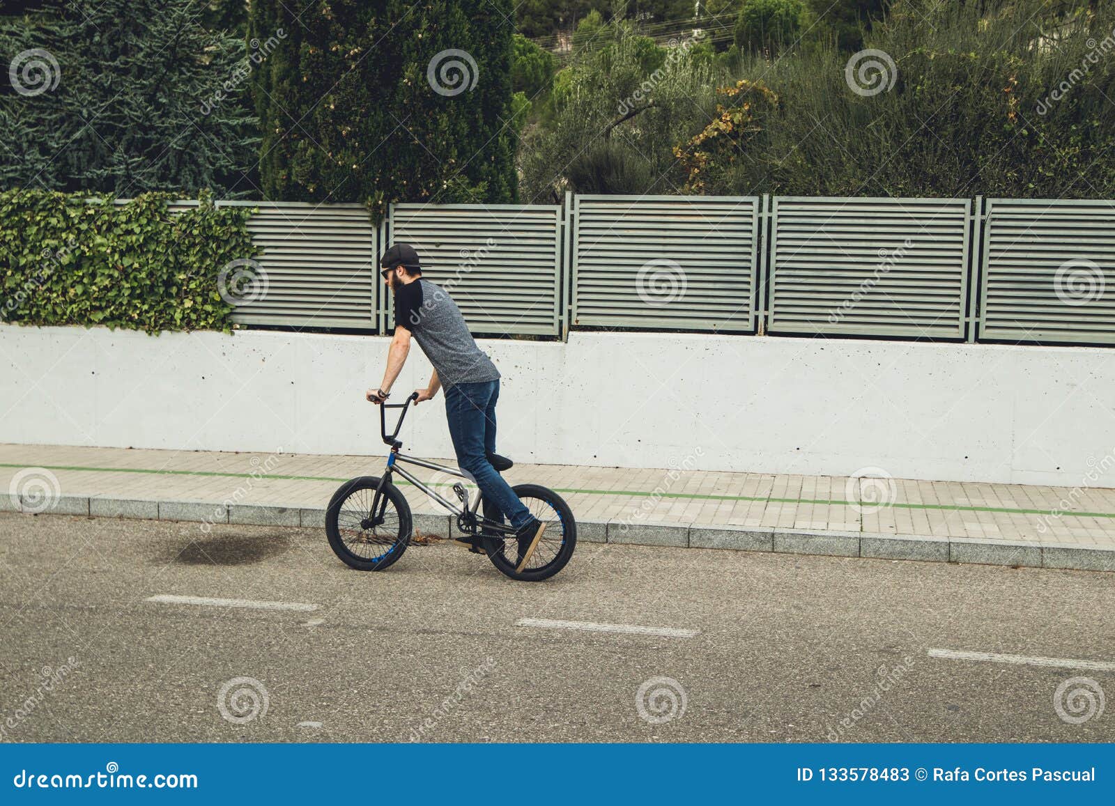 Guy riding his bicycle stock image. Image of casual - Guy RiDing His Bicycle Down Street 133578483