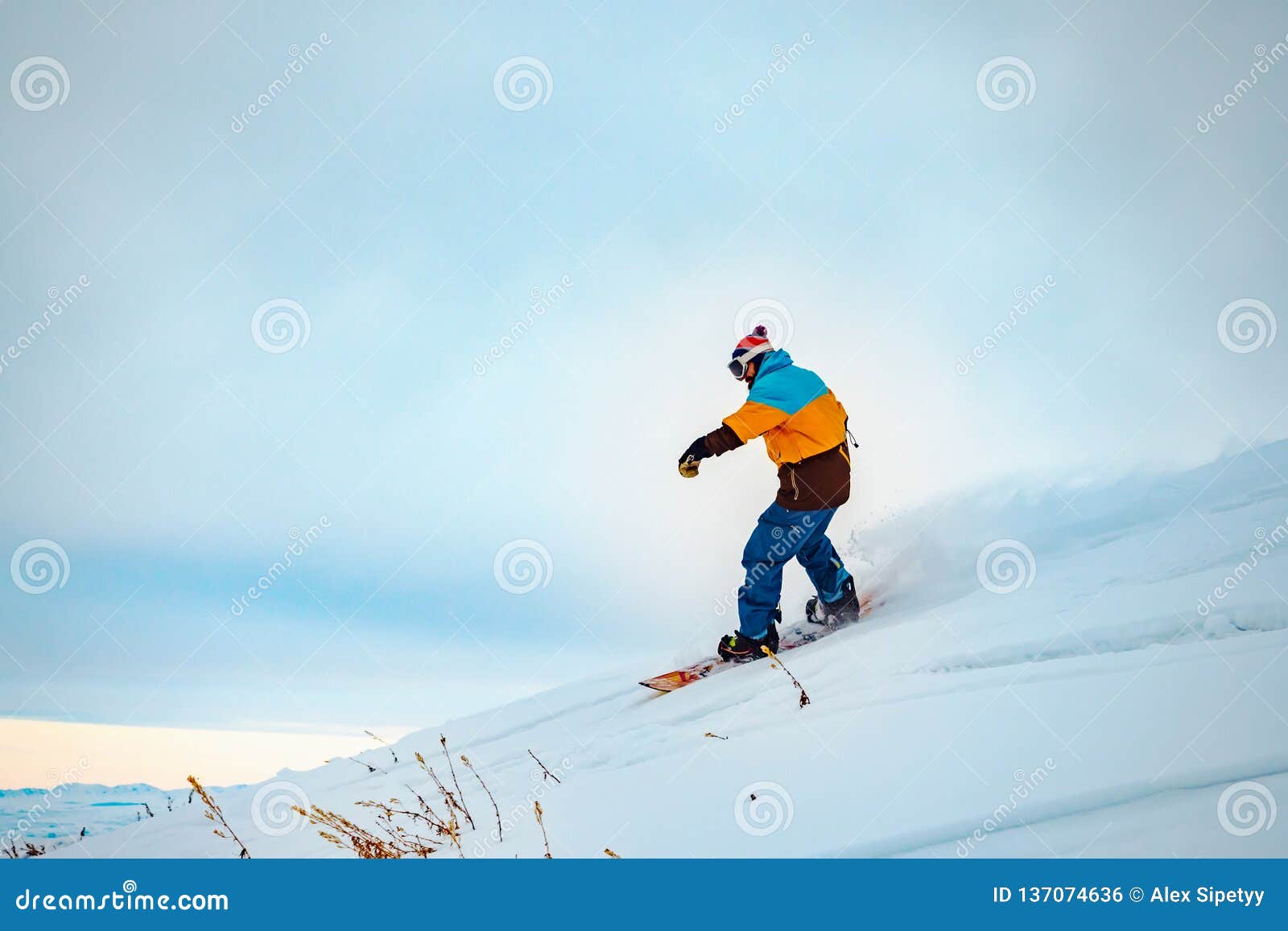 The Guy is Riding a Snowboard. in the Mountains in Pristine Snow Stock ...
