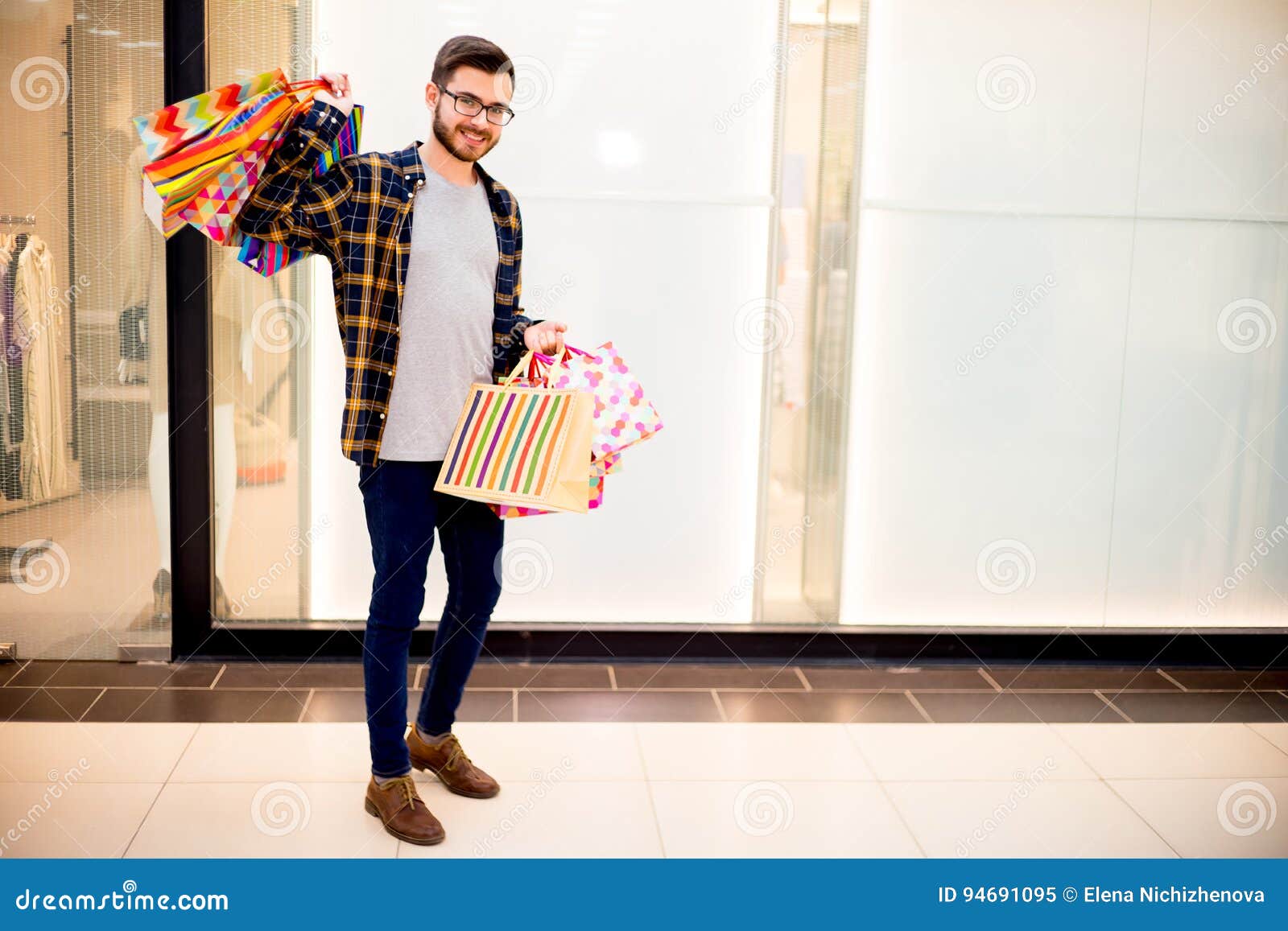 Guy shopping in a mall stock image. Image of clothes 94691095