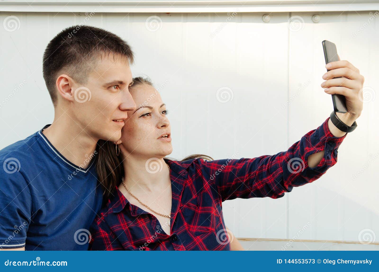 Guy With Short Haircut In Blue T Shirt And Girl With Dark