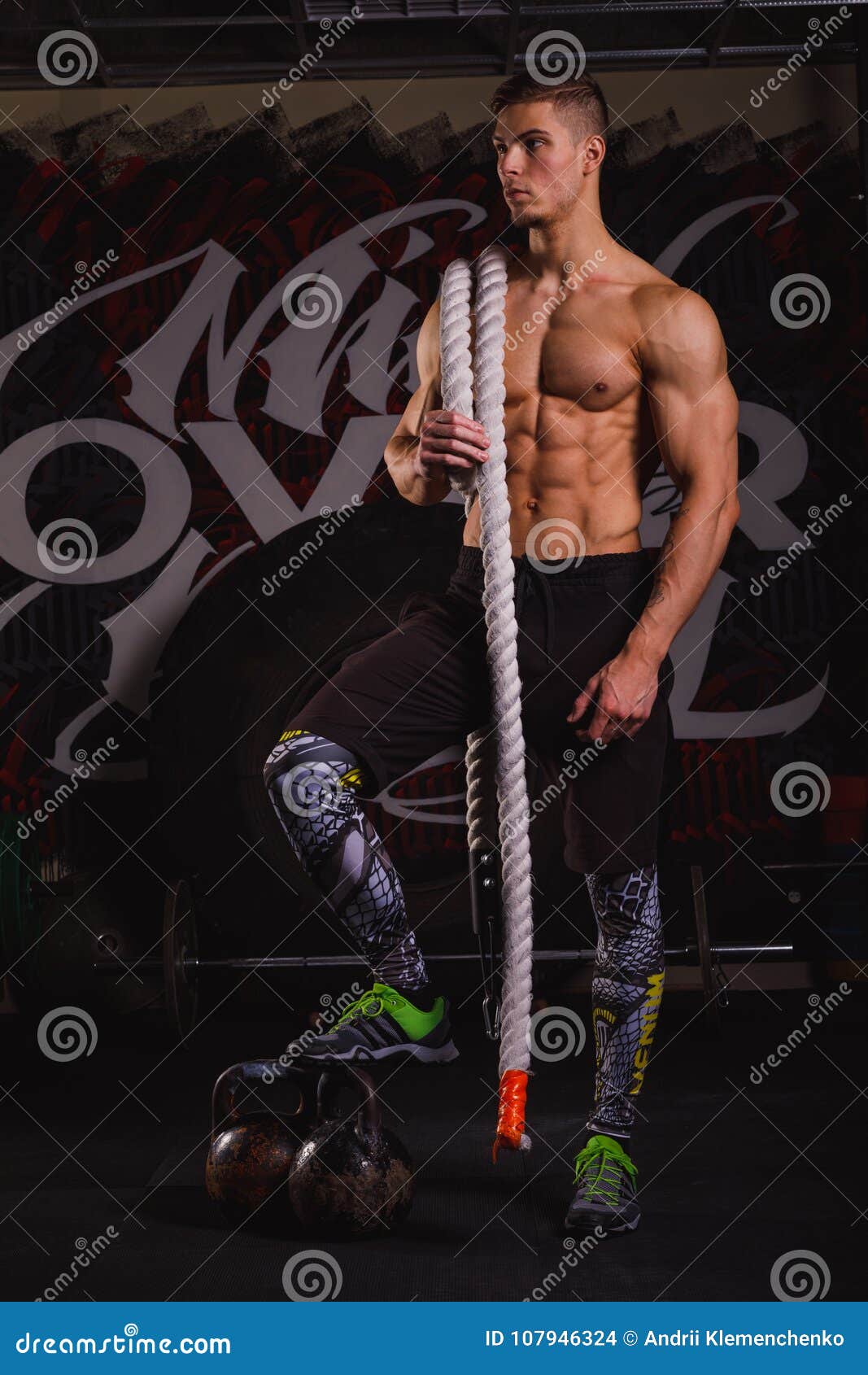A Guy, Stands Holding a Long Rope on Shoulder and Looks Away with a Serious  Look. Indoors in the Gym. Stock Photo - Image of active, lifestyles:  107946324