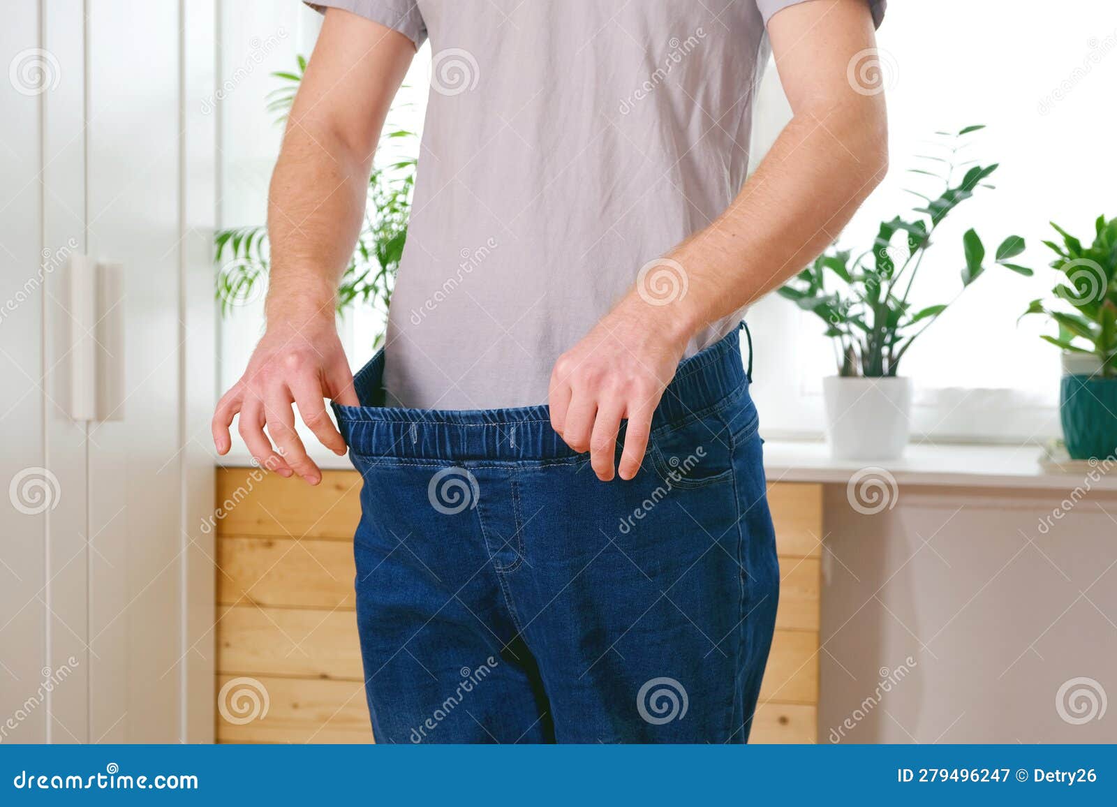 A pretty woman wearing her old pants before her weight loss - Stock Image -  Everypixel