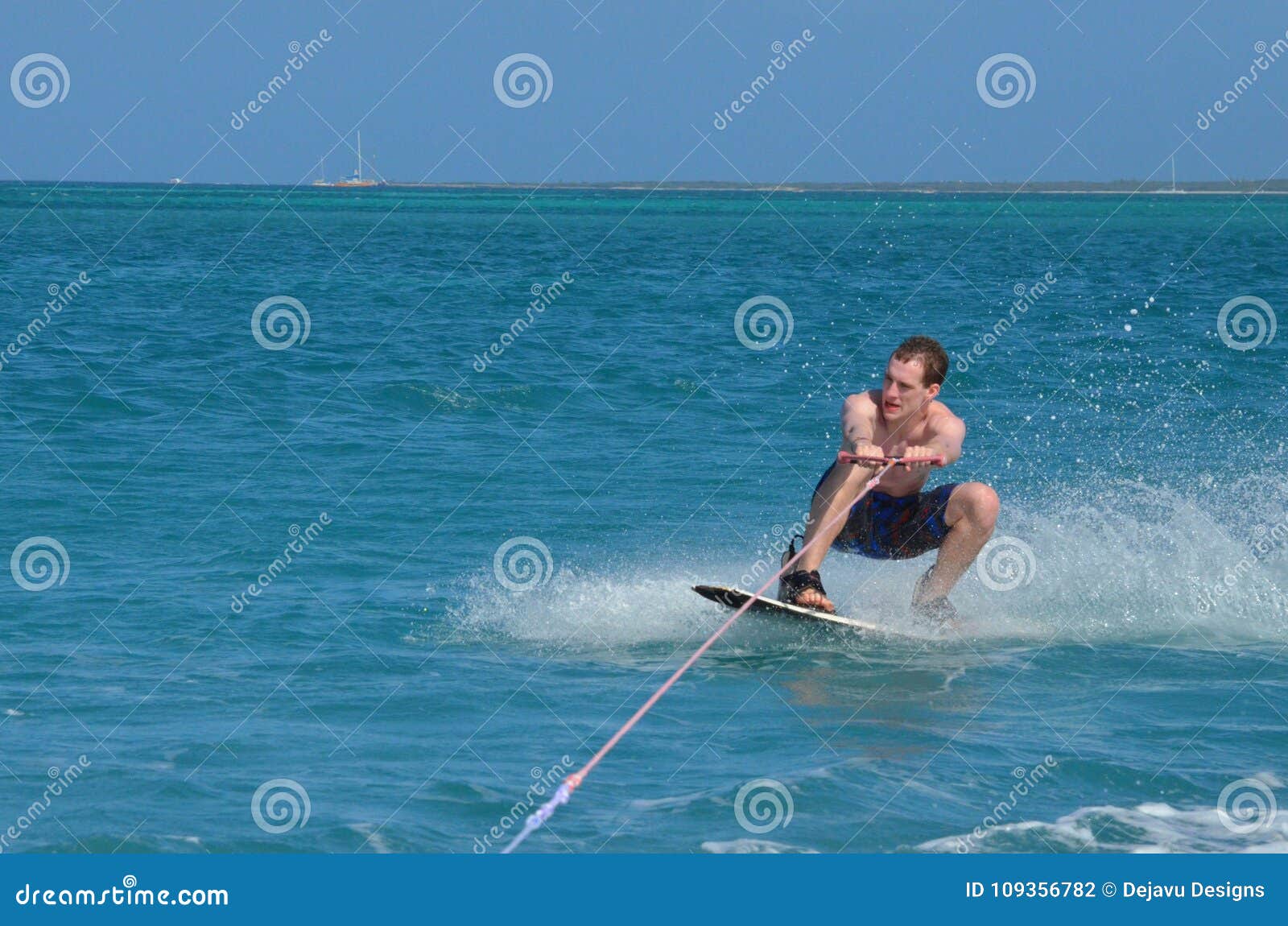 Guy Wakeboarding in a Crouch Ready To Pull a Trick Stock Photo Image