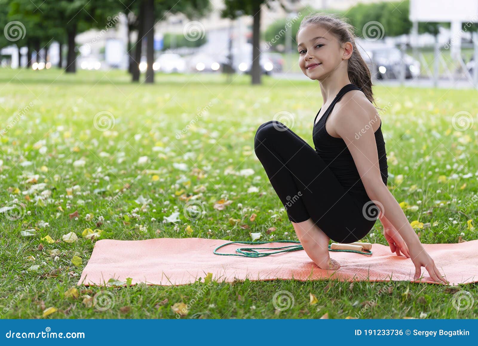 Gymnast Schoolgirl Warming Up in a Grass Park before Performing Complex ...