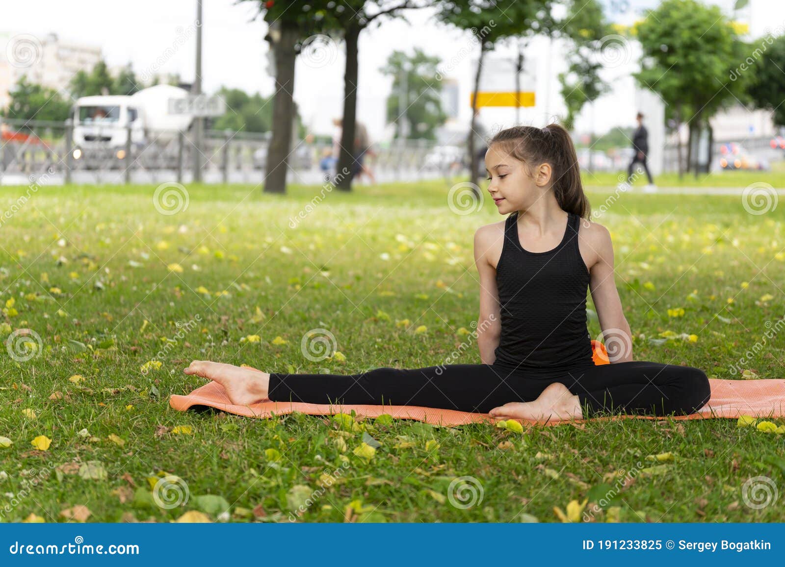 Gymnast Schoolgirl Warming Up in a Grass Park before Performing Complex ...