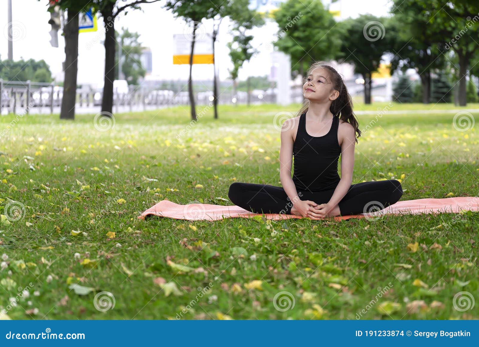 Gymnast Schoolgirl Warming Up in a Grass Park before Performing Complex ...