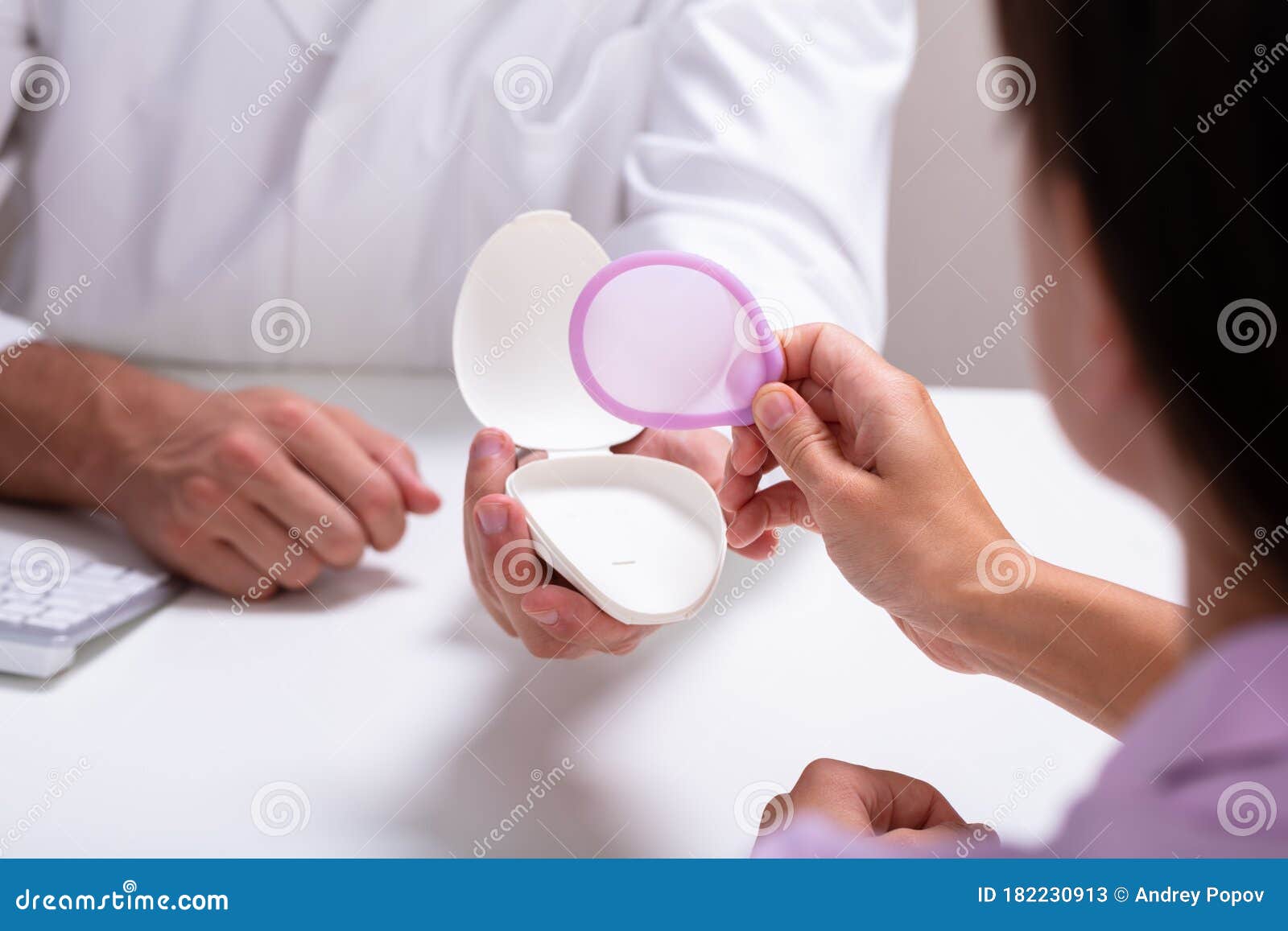 Gynecologist Consulting Woman on Diaphragm Contraception Method Stock