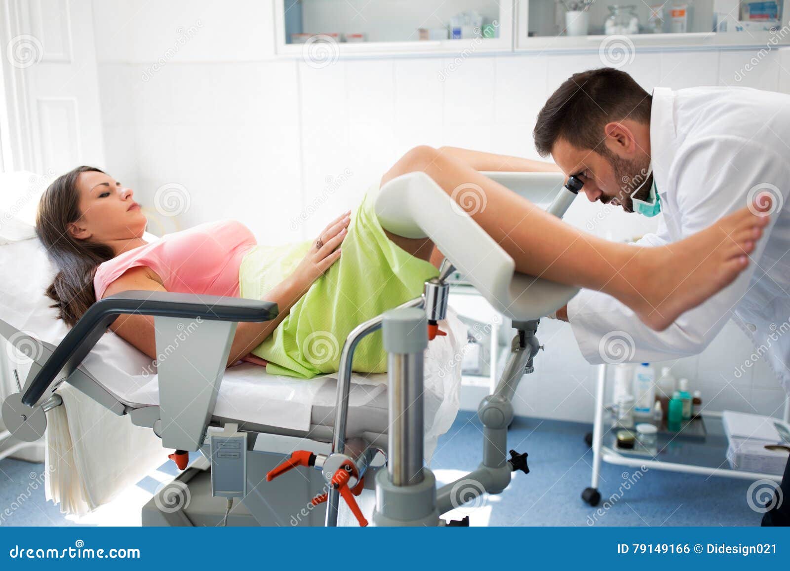 gynecologist examining a patient with a colposcope