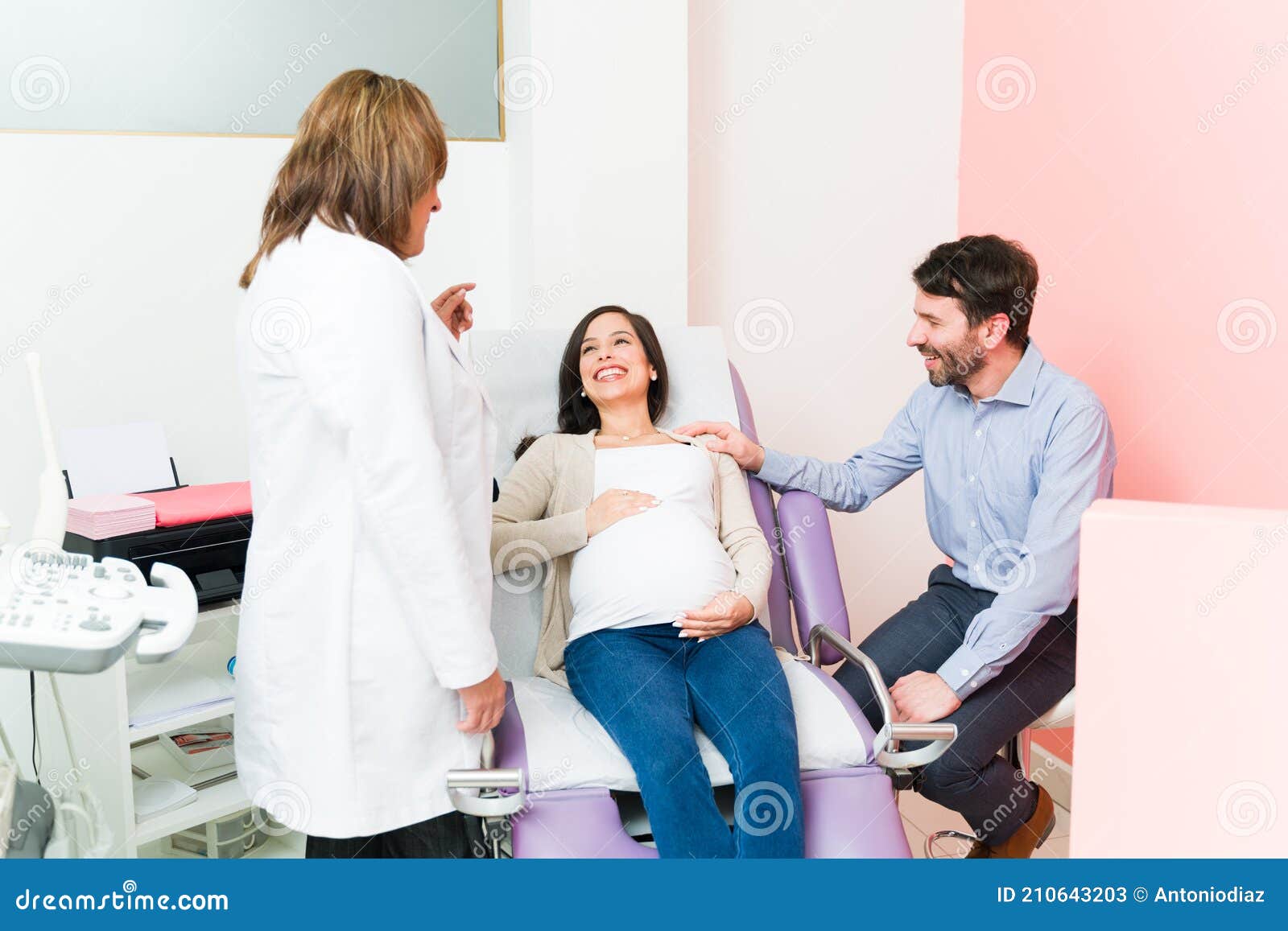 Female Doctor Telling a Pregnant Couple the Sex of Their Baby Stock Image