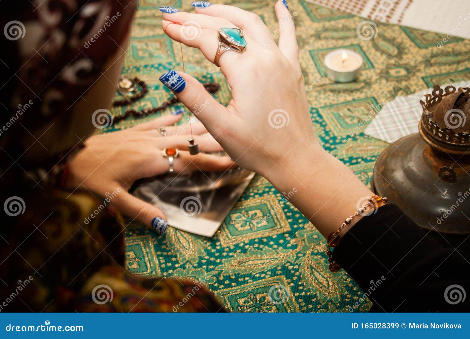 gypsy psychic looking for a man in a photo using a pendulum. love spell on photos