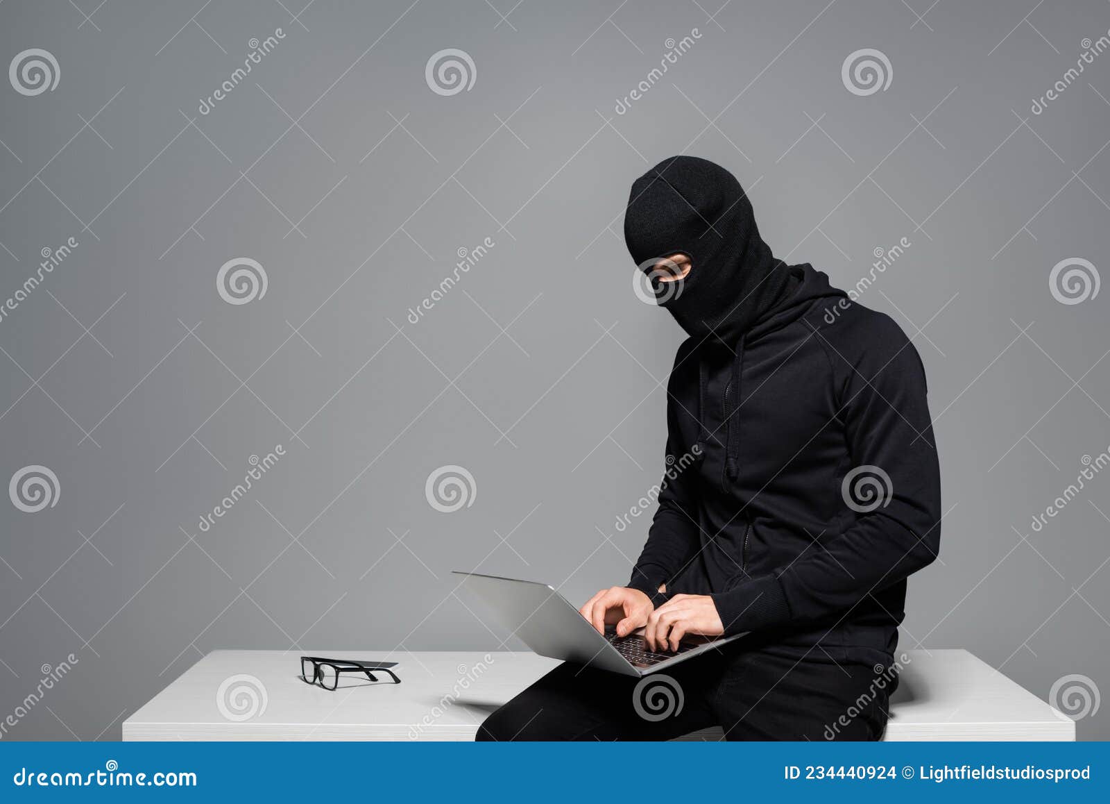 Hacker in Balaclava Using Laptop Near Stock Photo - Image of technology ...