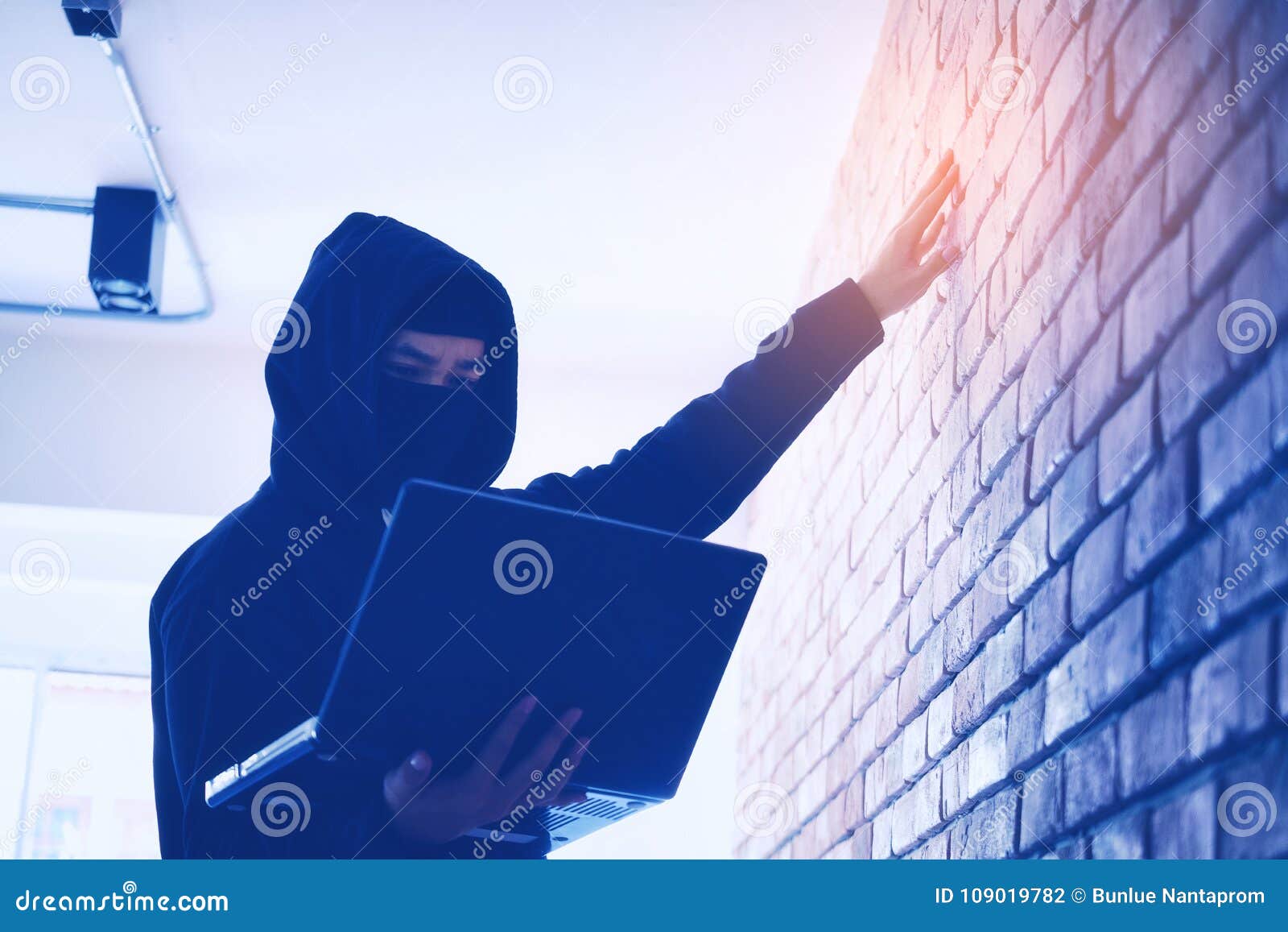 hacker holding gun working on his computer, war, terrorism , ter