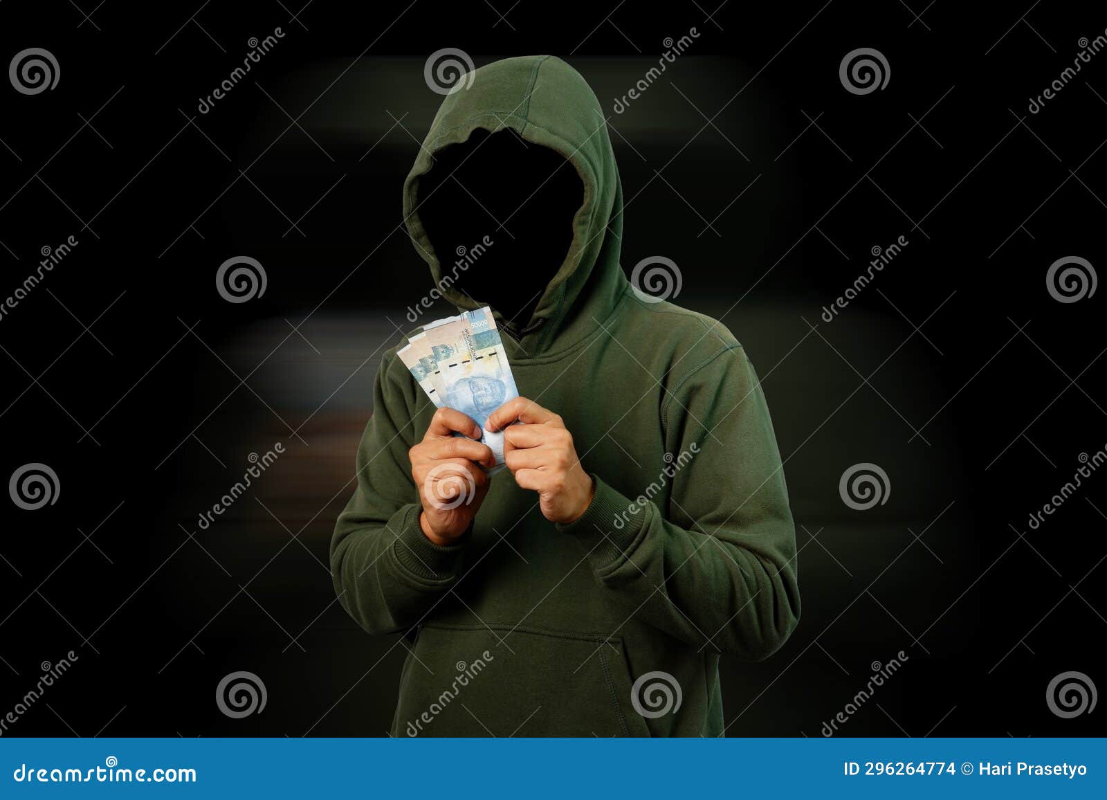 hacker holding rupiah paper money  on black background. motion blur mode