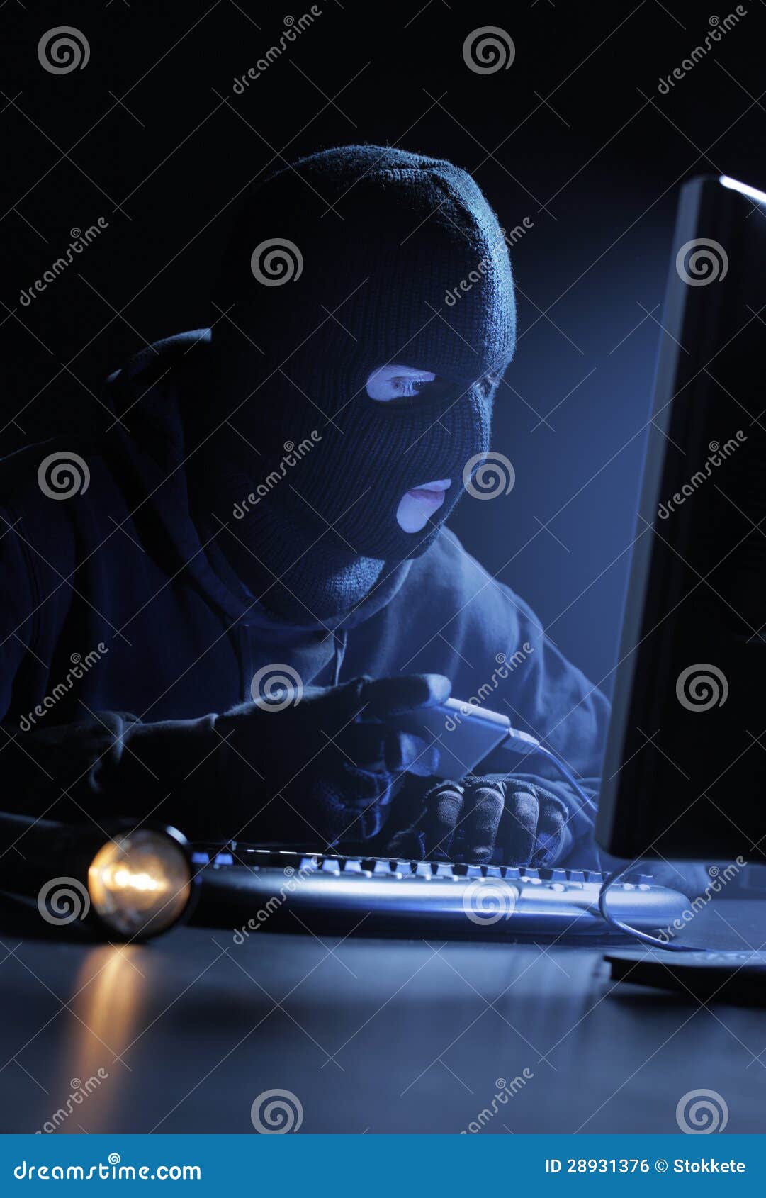 Hacker stealing data. Computer hacker - Male thief stealing data from computer