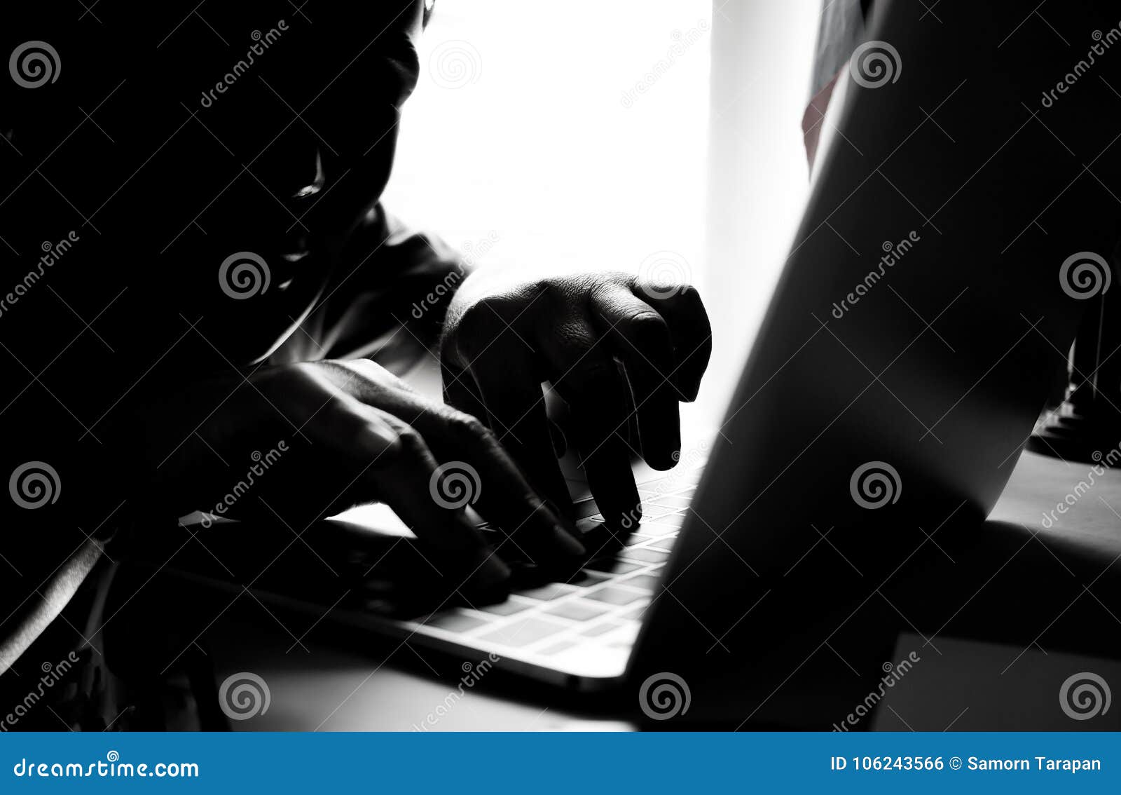 hackers with black mask using hands of anonymous typing code on