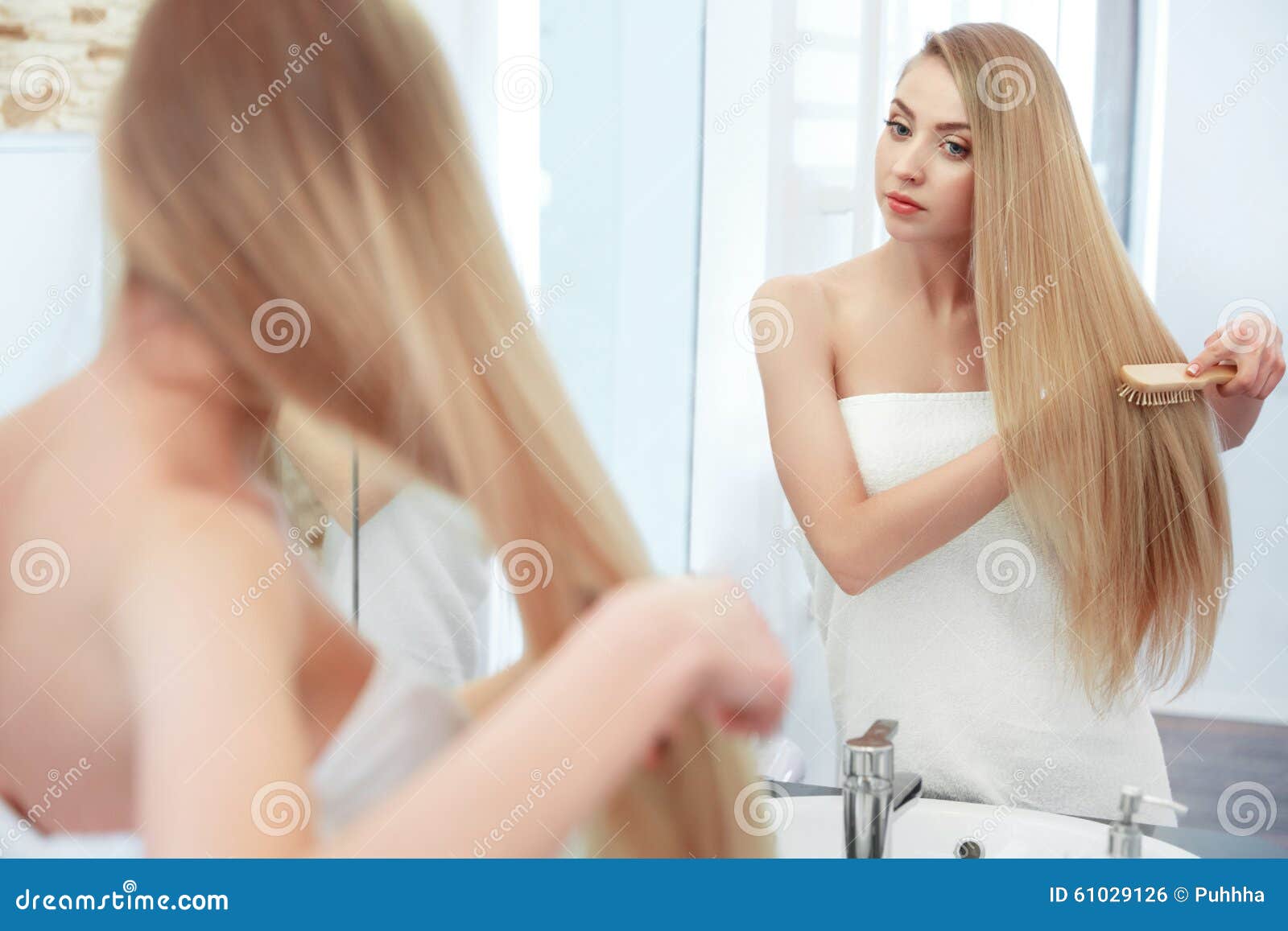 hair. beautiful blond brushing her hair. hair care. spa beauty m